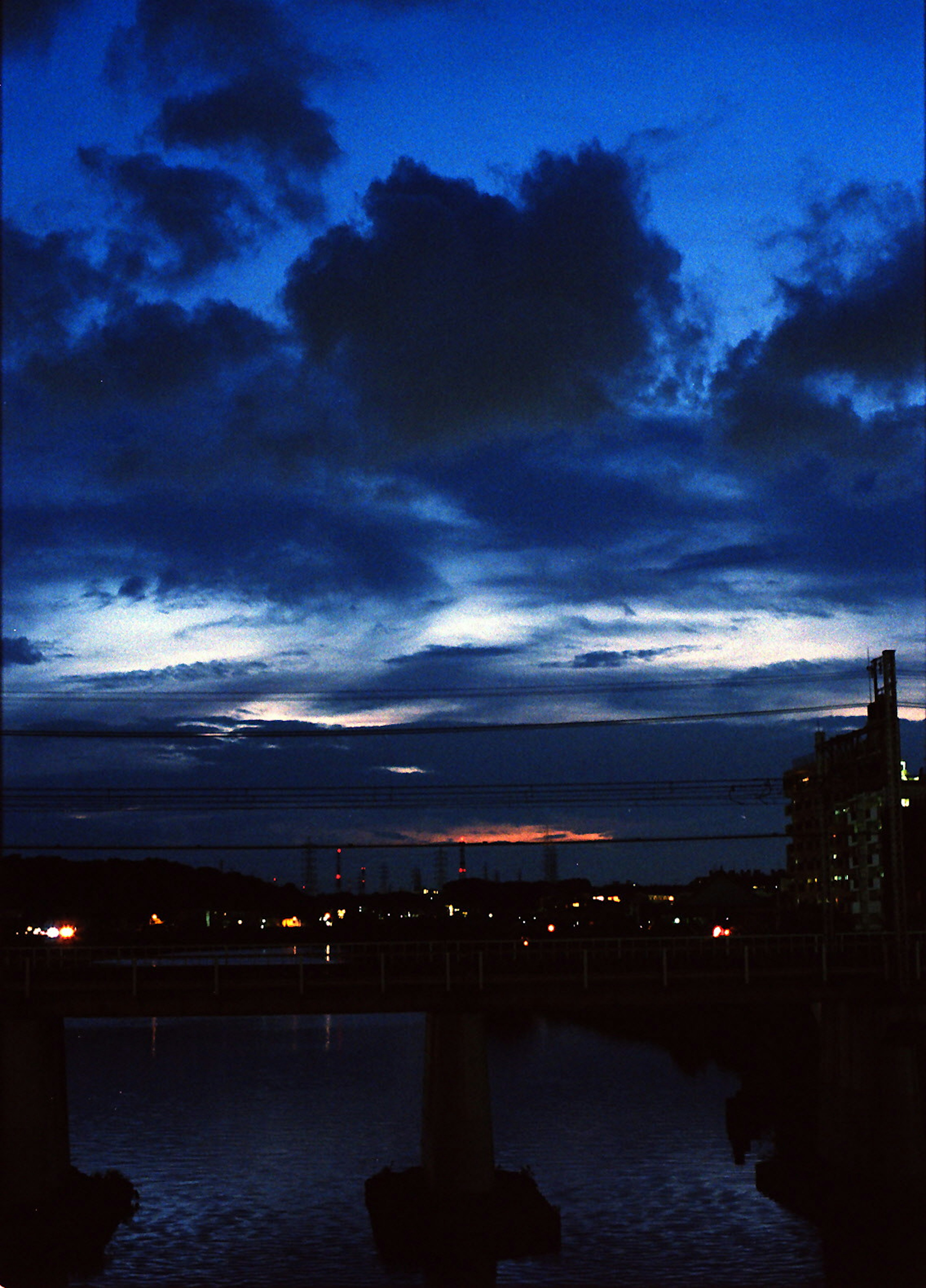 Night sky with clouds and reflections on the water