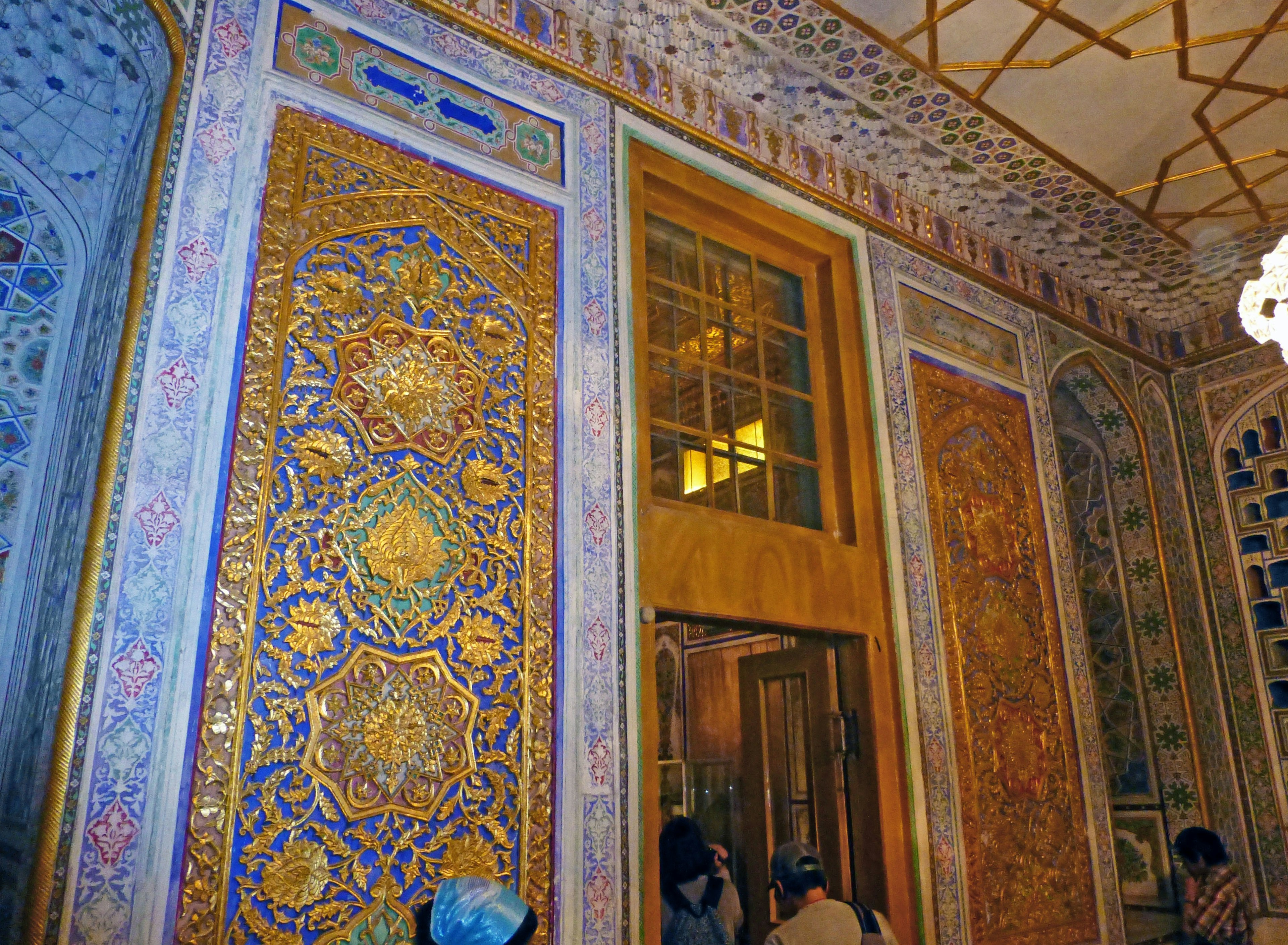 Intricate tile decorations and golden details on a wall