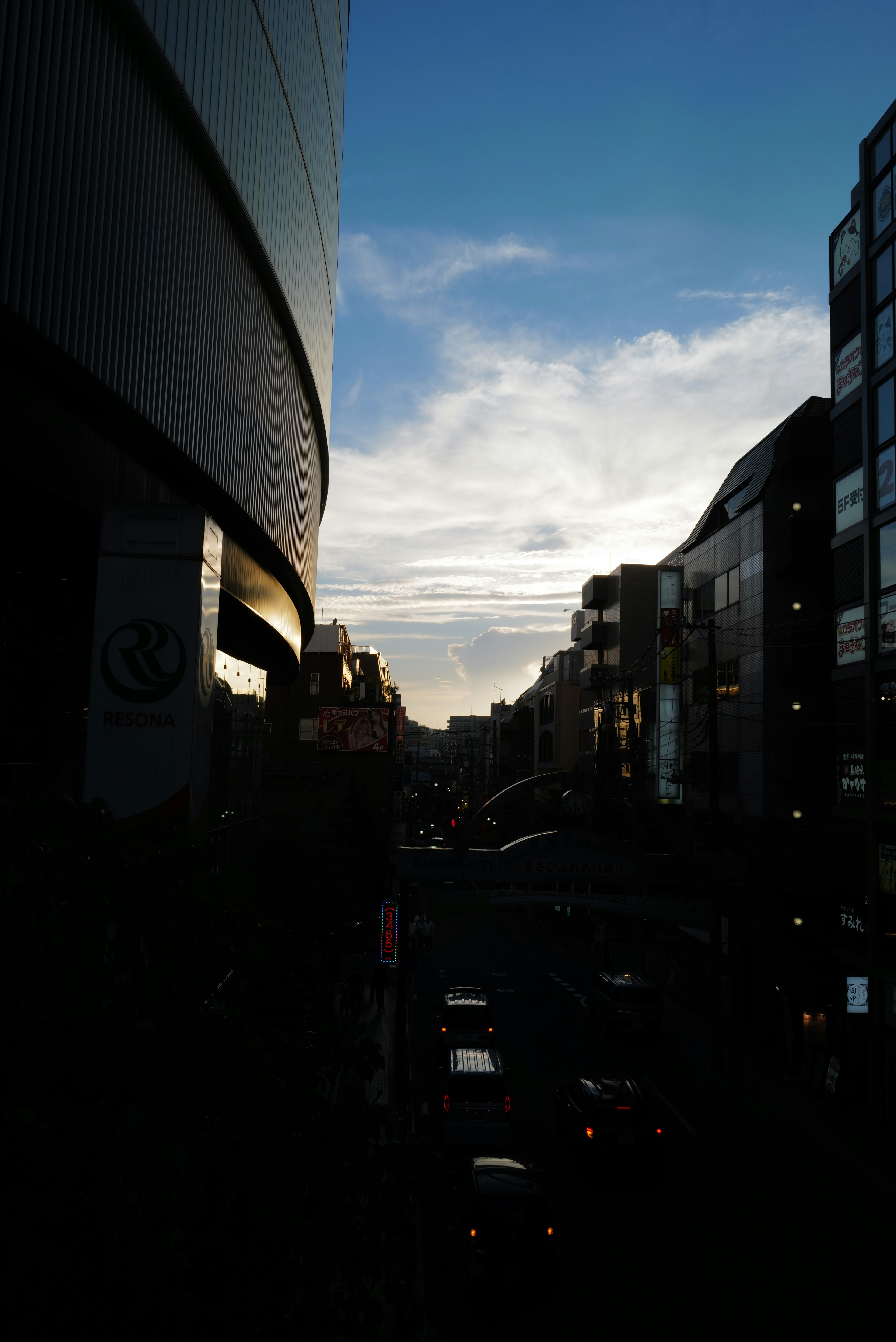 Cityscape at dusk with blue sky and clouds