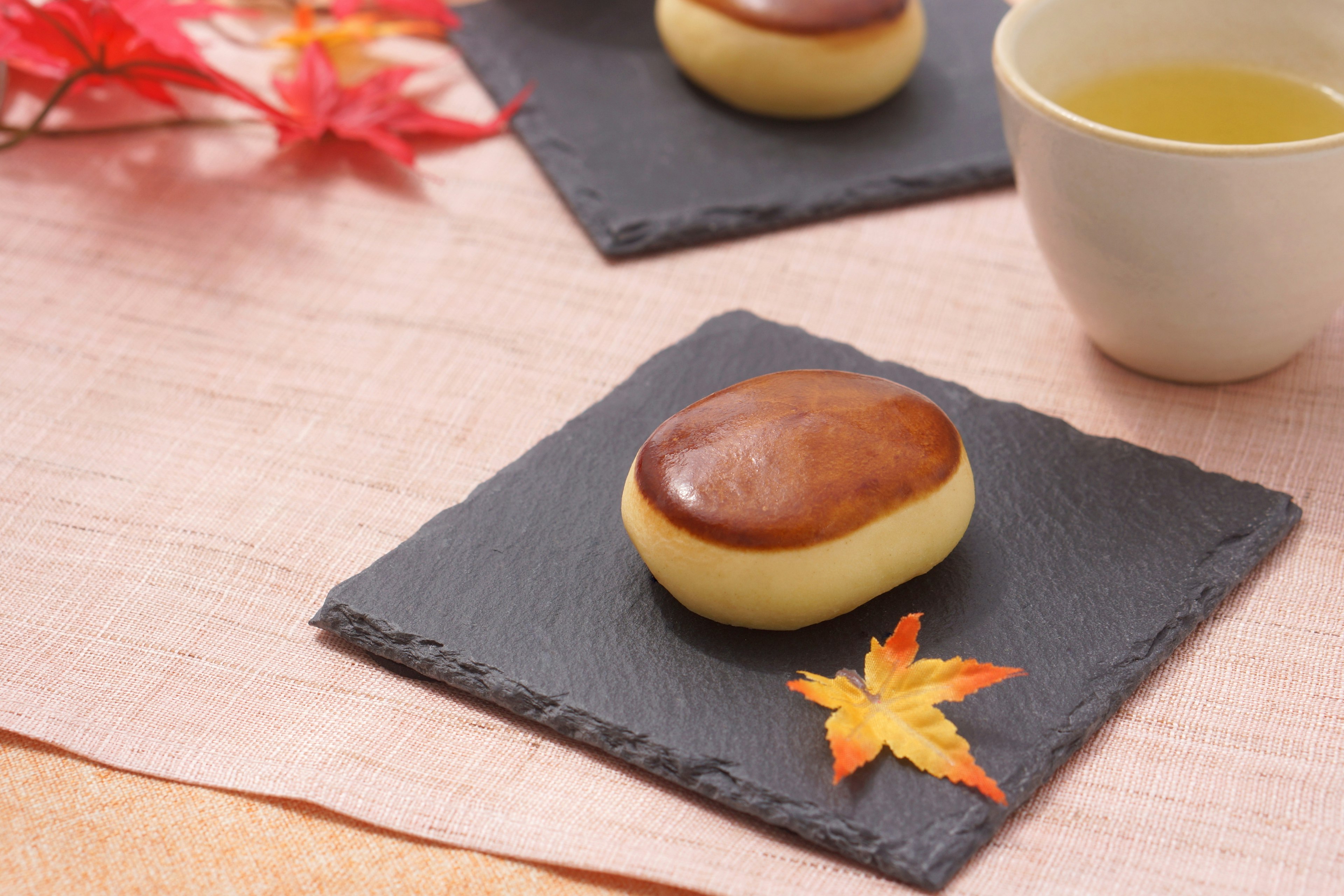 Una exhibición serena de dulces japoneses tradicionales y té con hojas de otoño