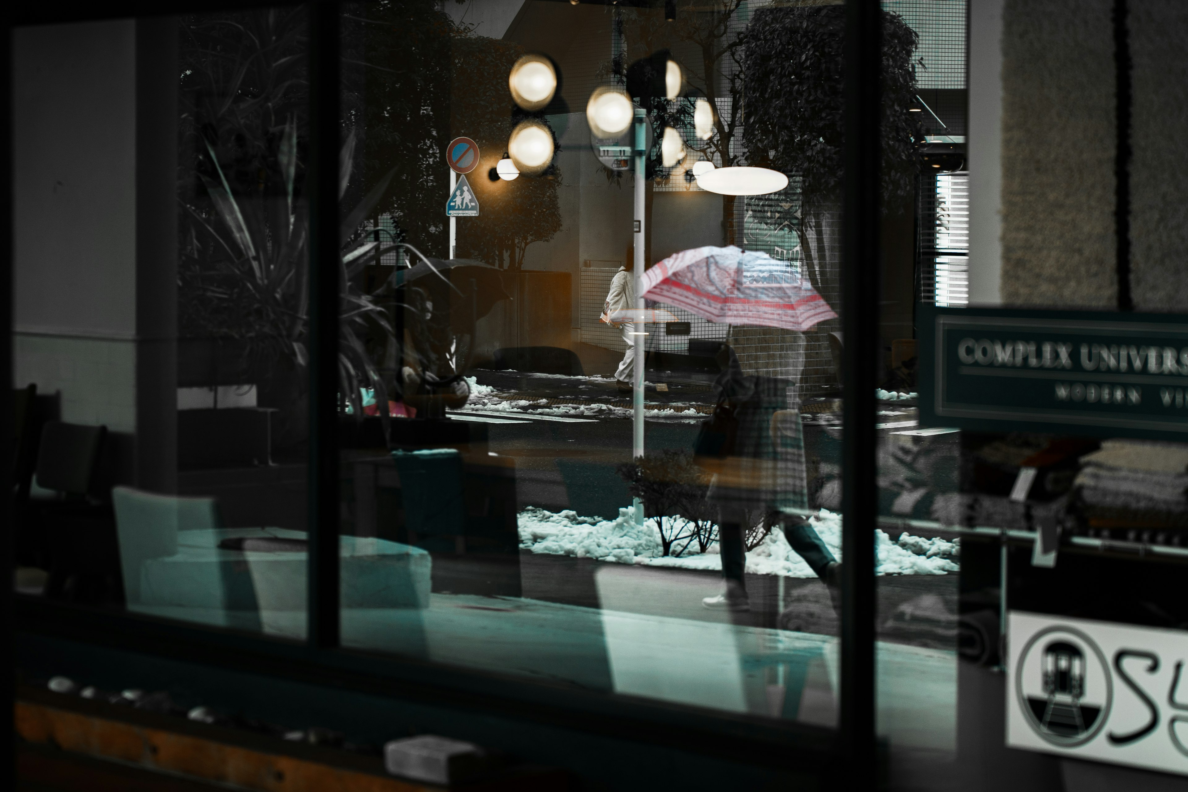 Interior view through a window showcasing lights and an umbrella