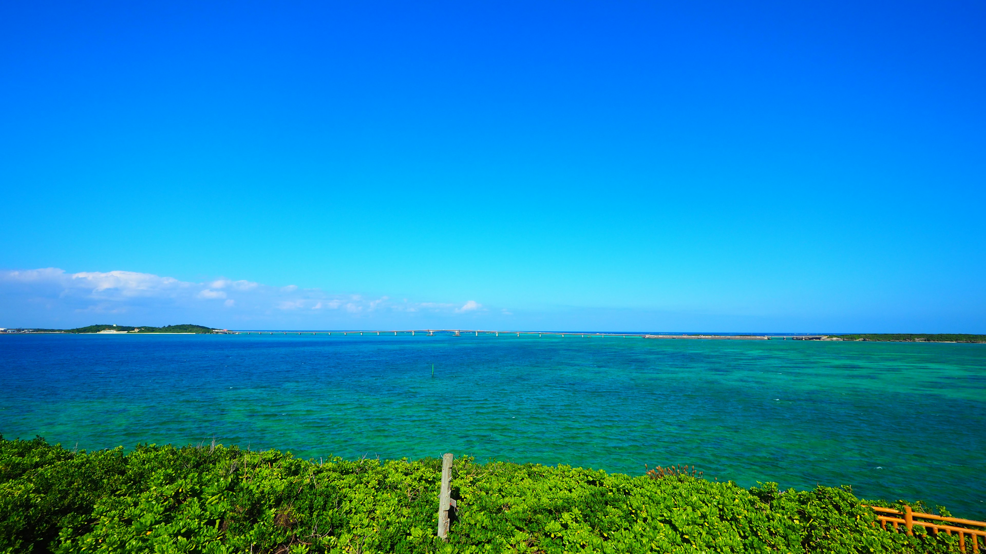 Scenic view of blue sky and green ocean