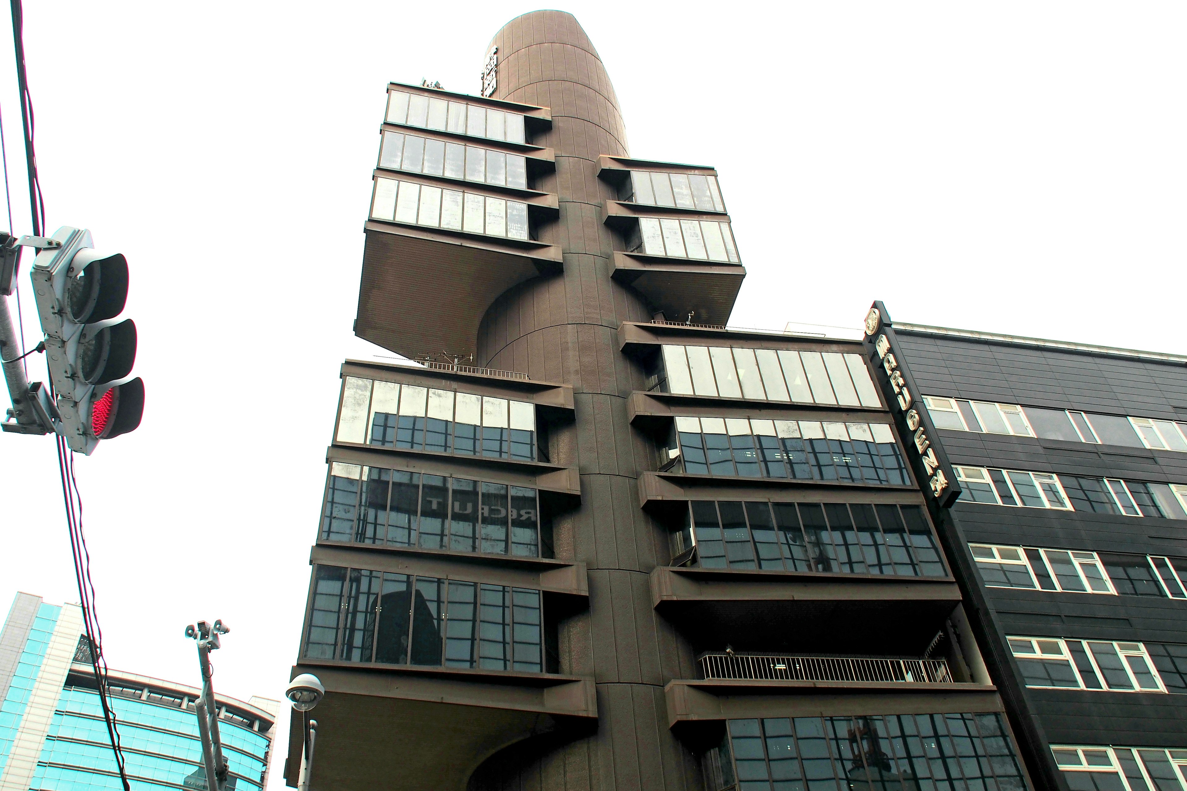 A modern high-rise building captured from a low angle showcasing its unique architectural design