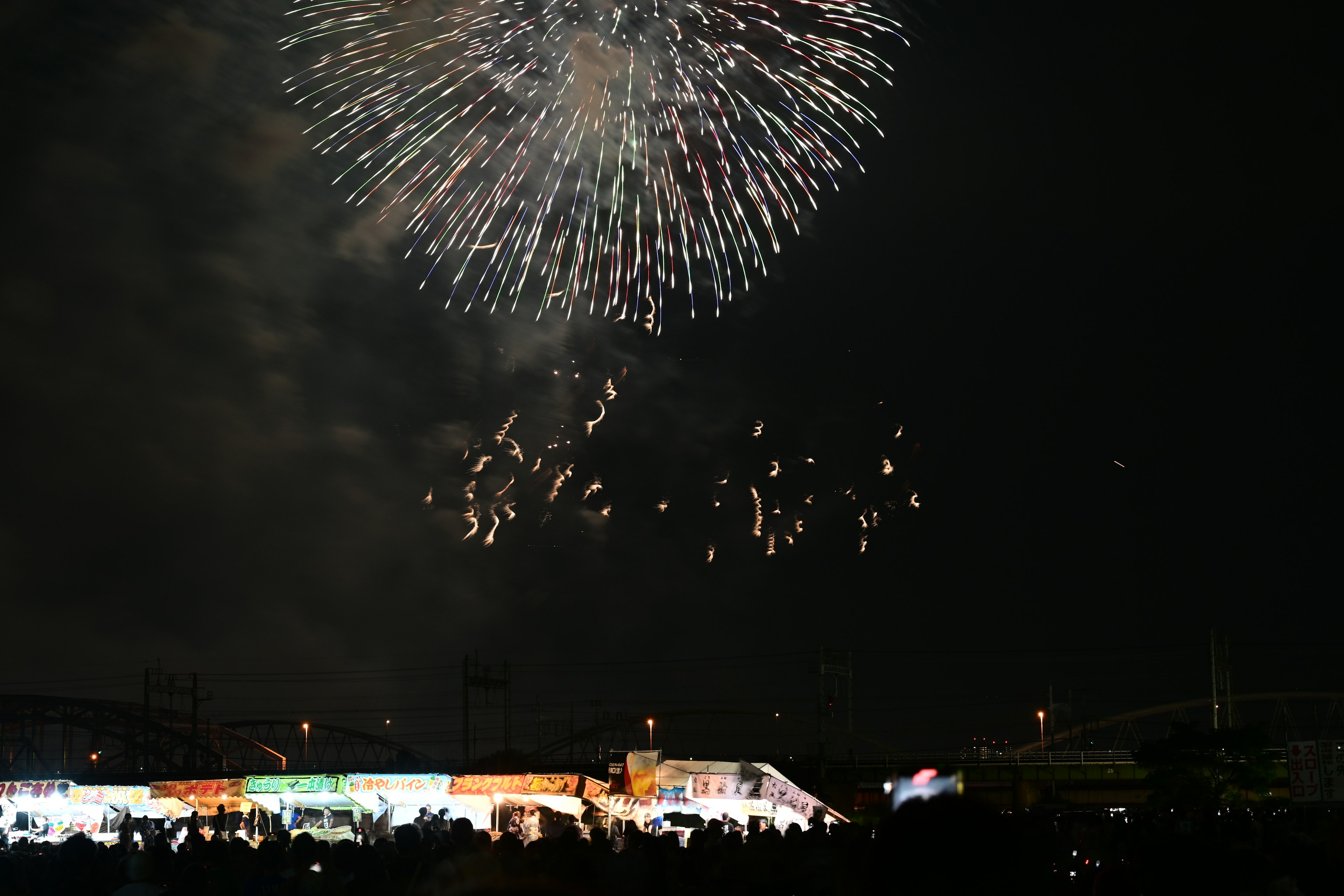 Fireworks display over a festival at night