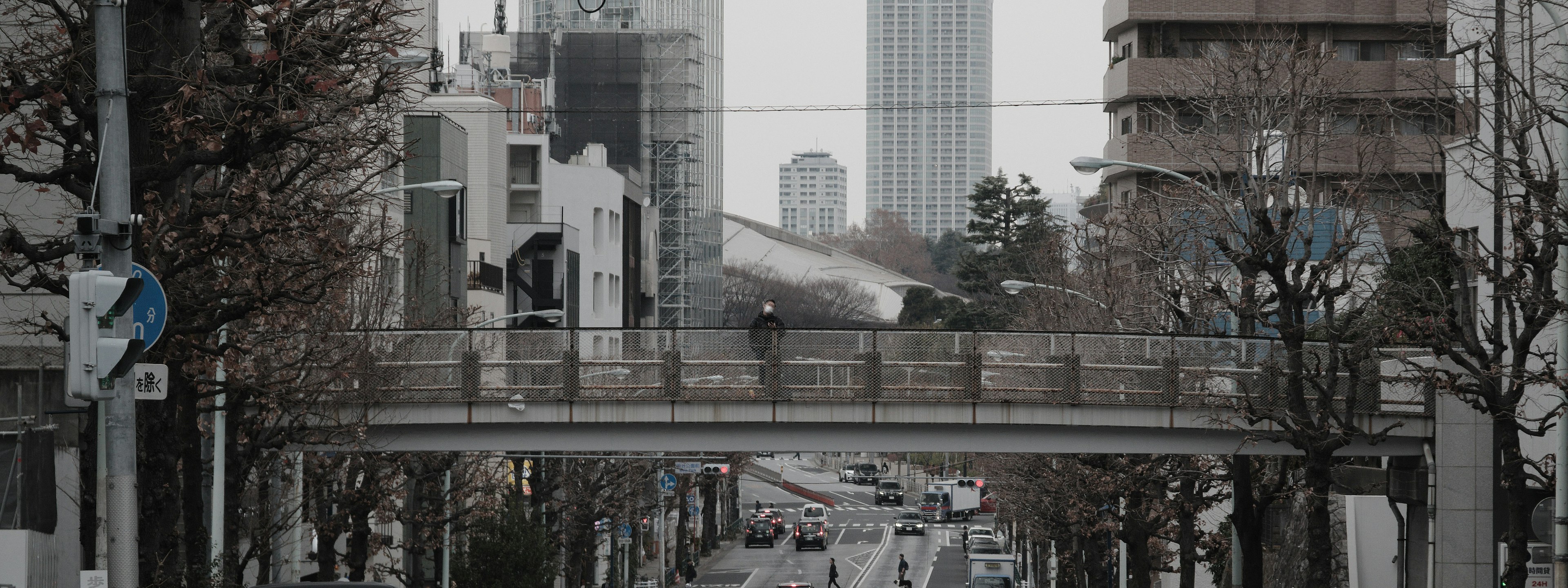 Pedestrian bridge in an urban landscape with surrounding skyscrapers