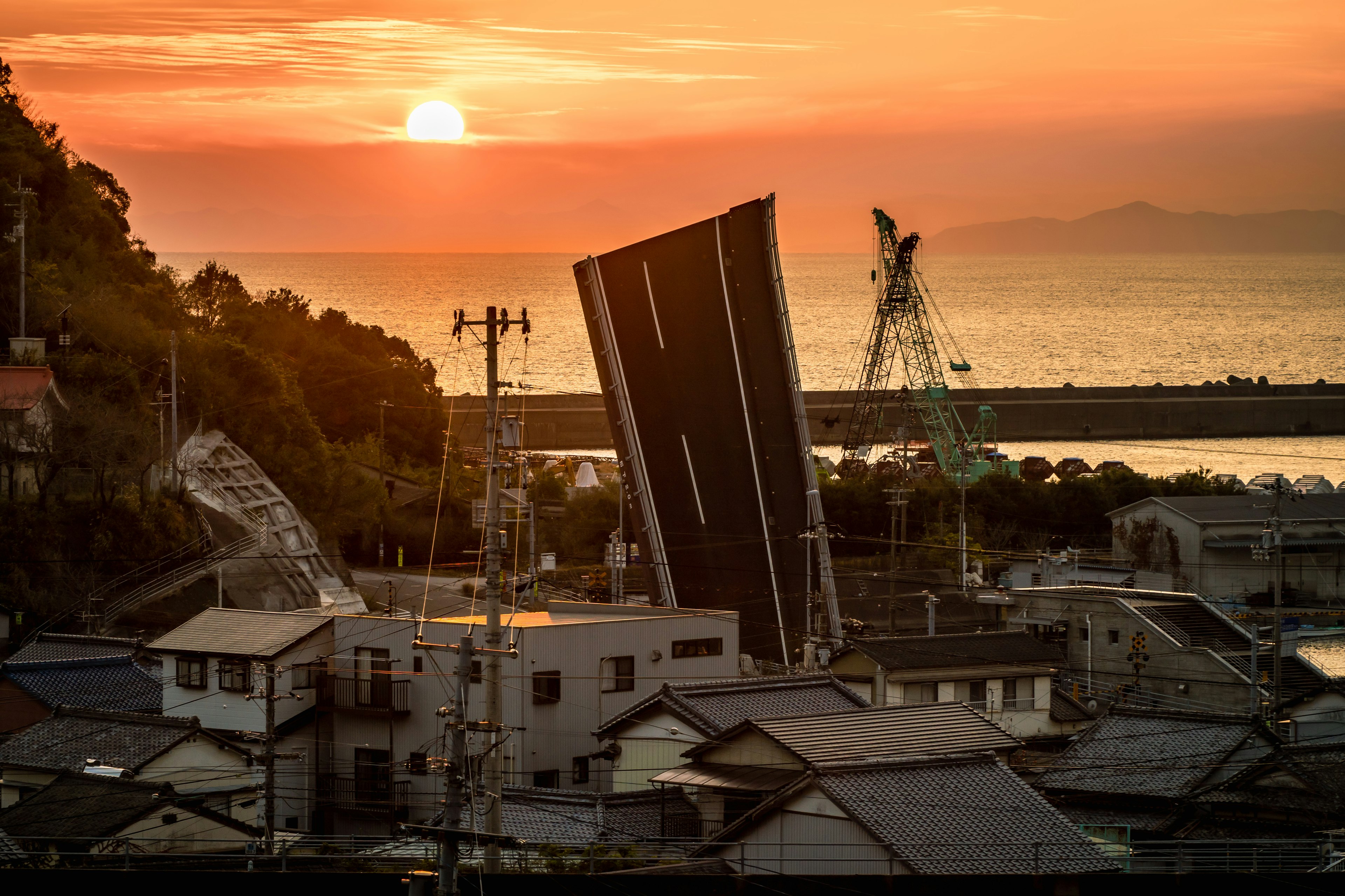 Coastal landscape with a sunset and a tilted building