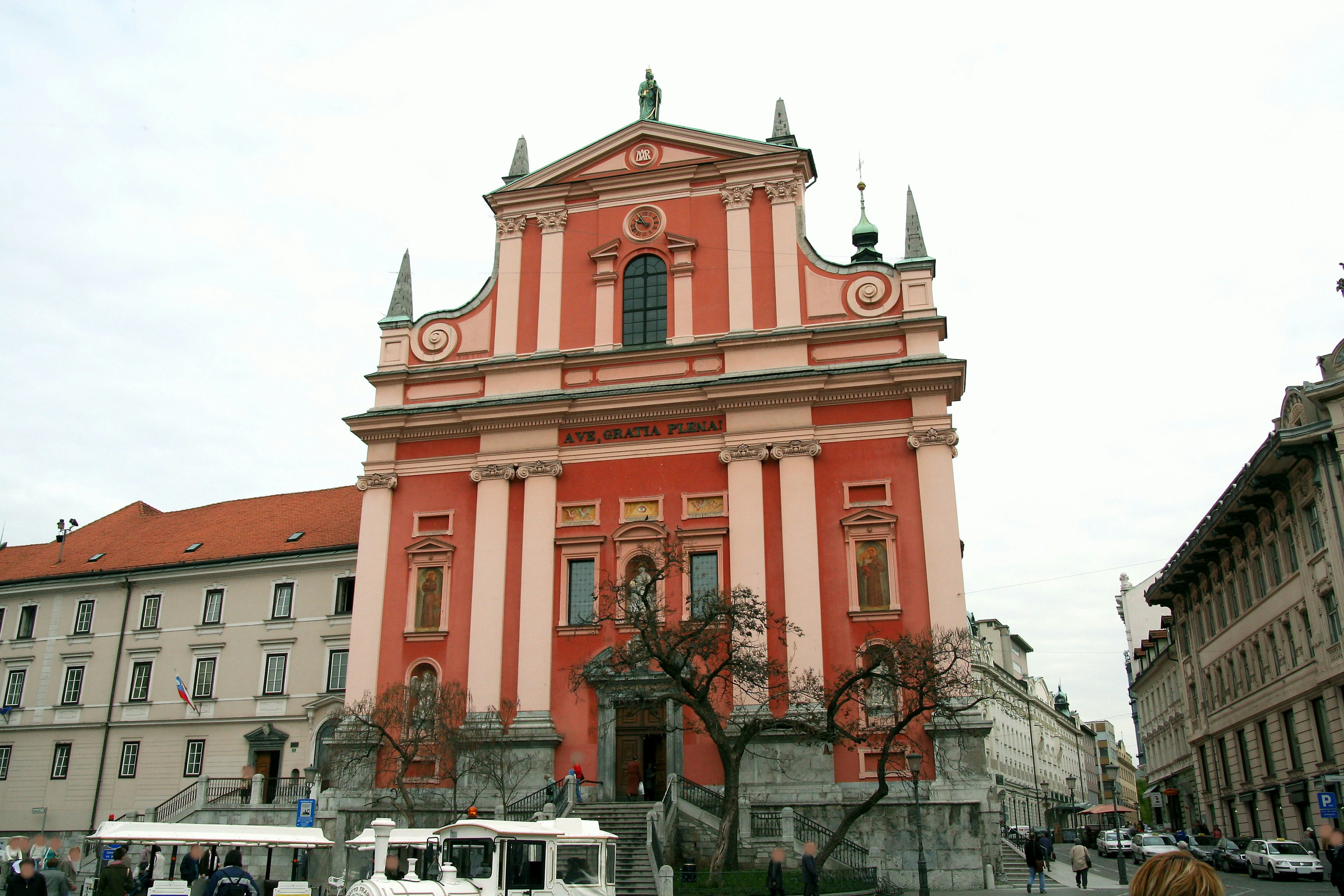 Beautiful exterior of St Nicholas Cathedral in Ljubljana featuring red and white stripes