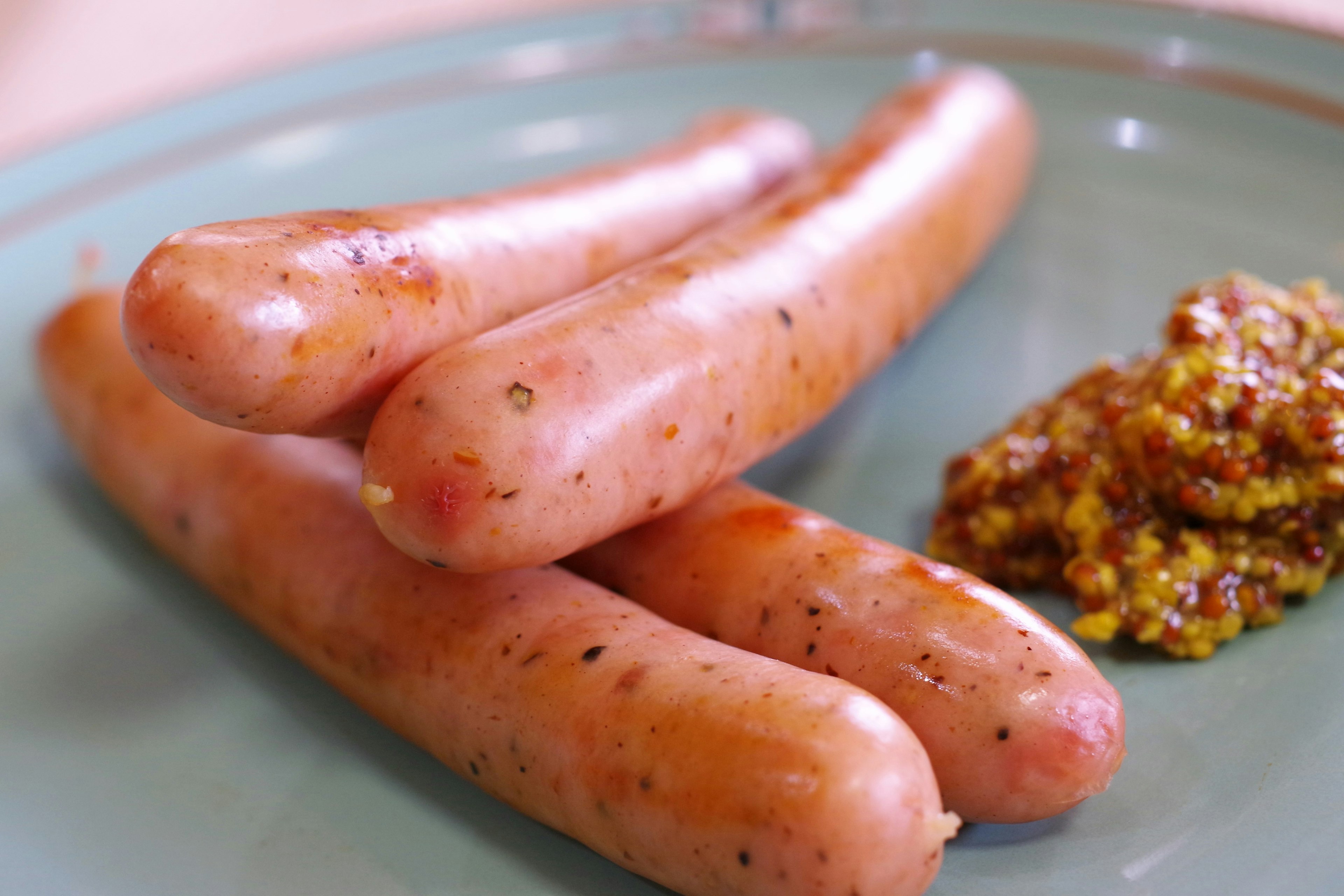 Sausages arranged on a plate with mustard