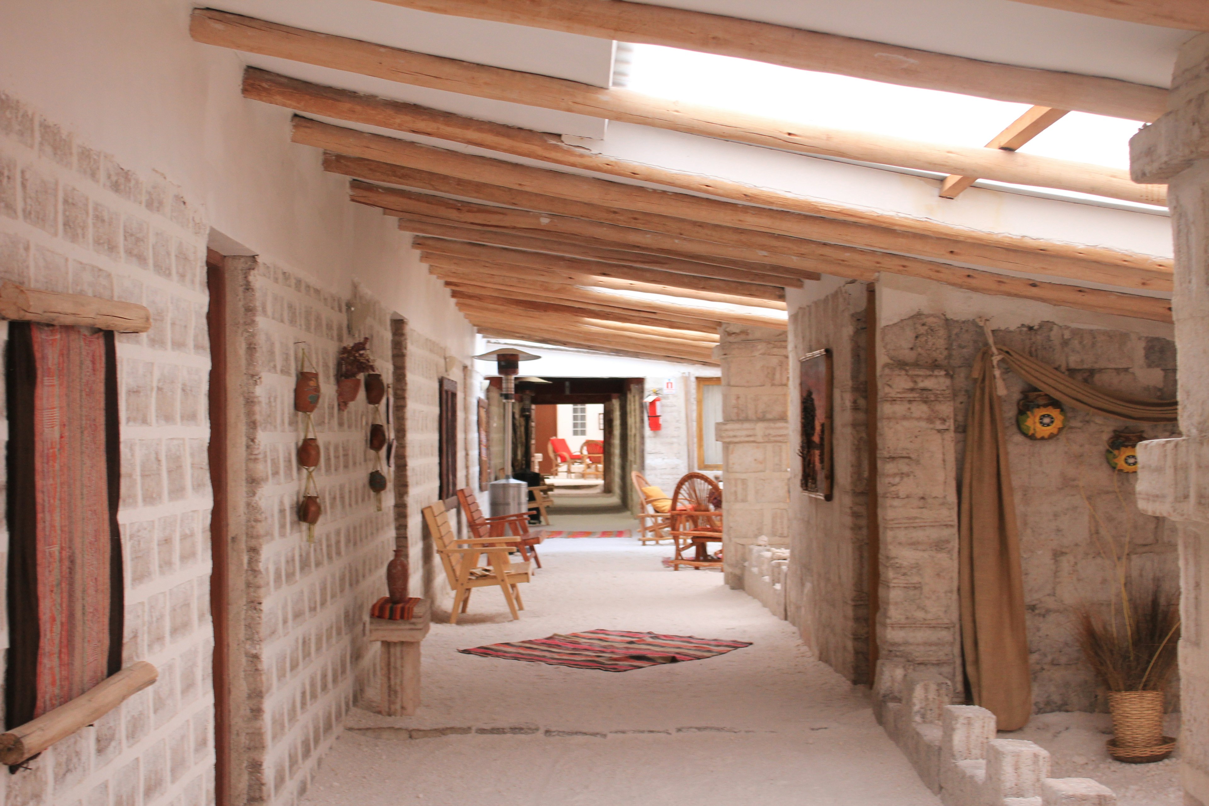 Interior corridor featuring wooden beams and stone walls