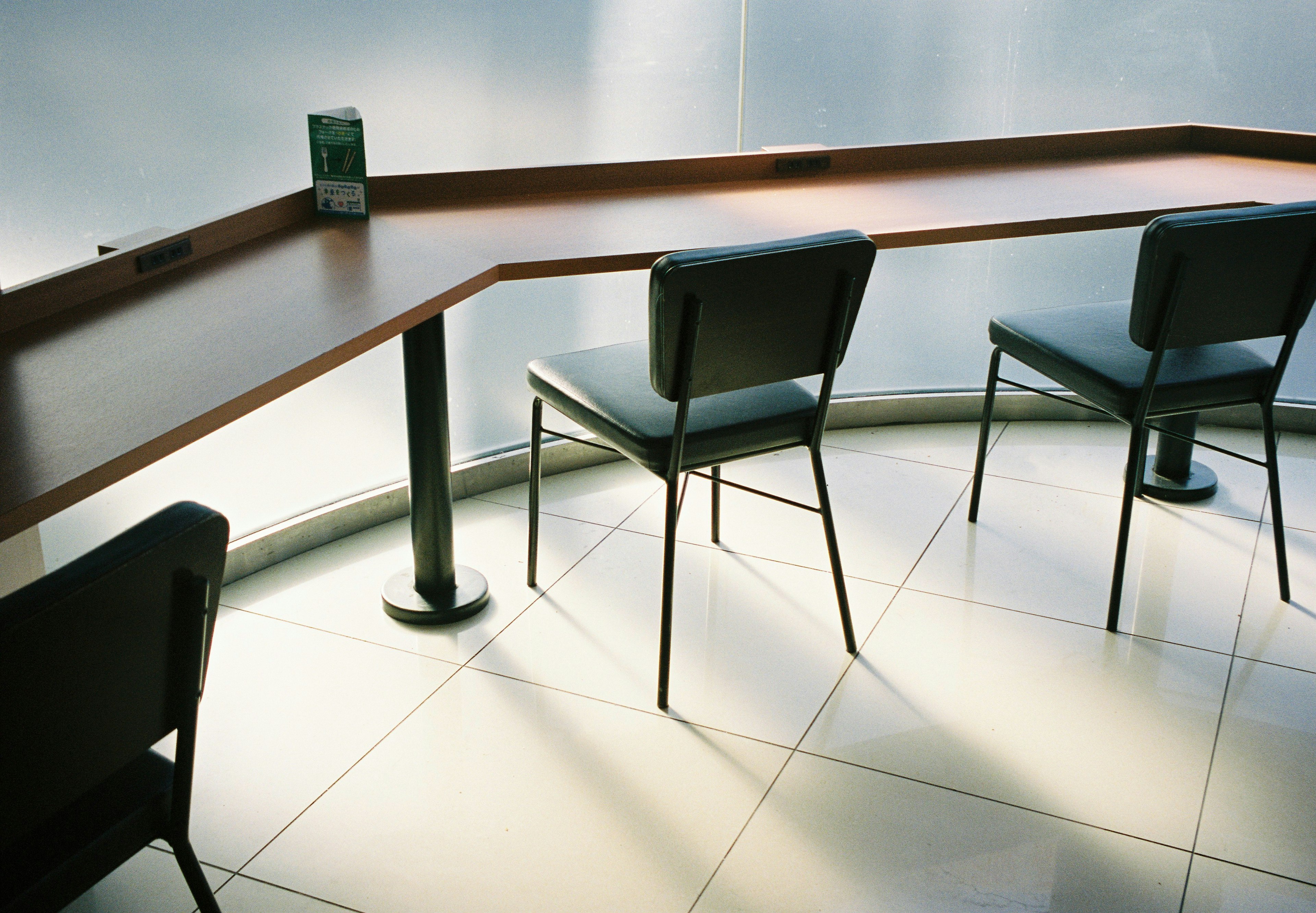 Minimalist counter with black chairs in a bright space