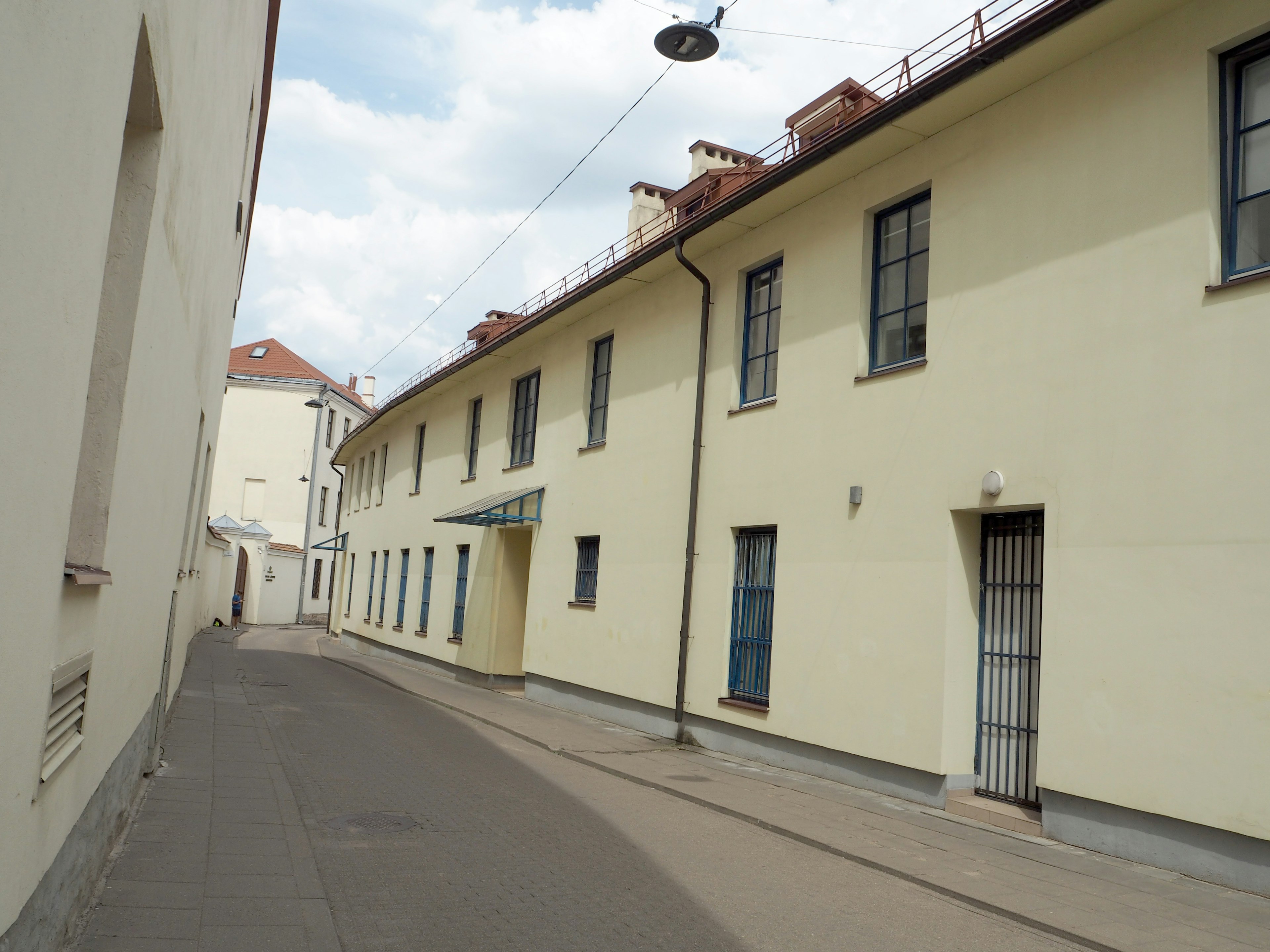 Narrow street with yellow buildings lining the side