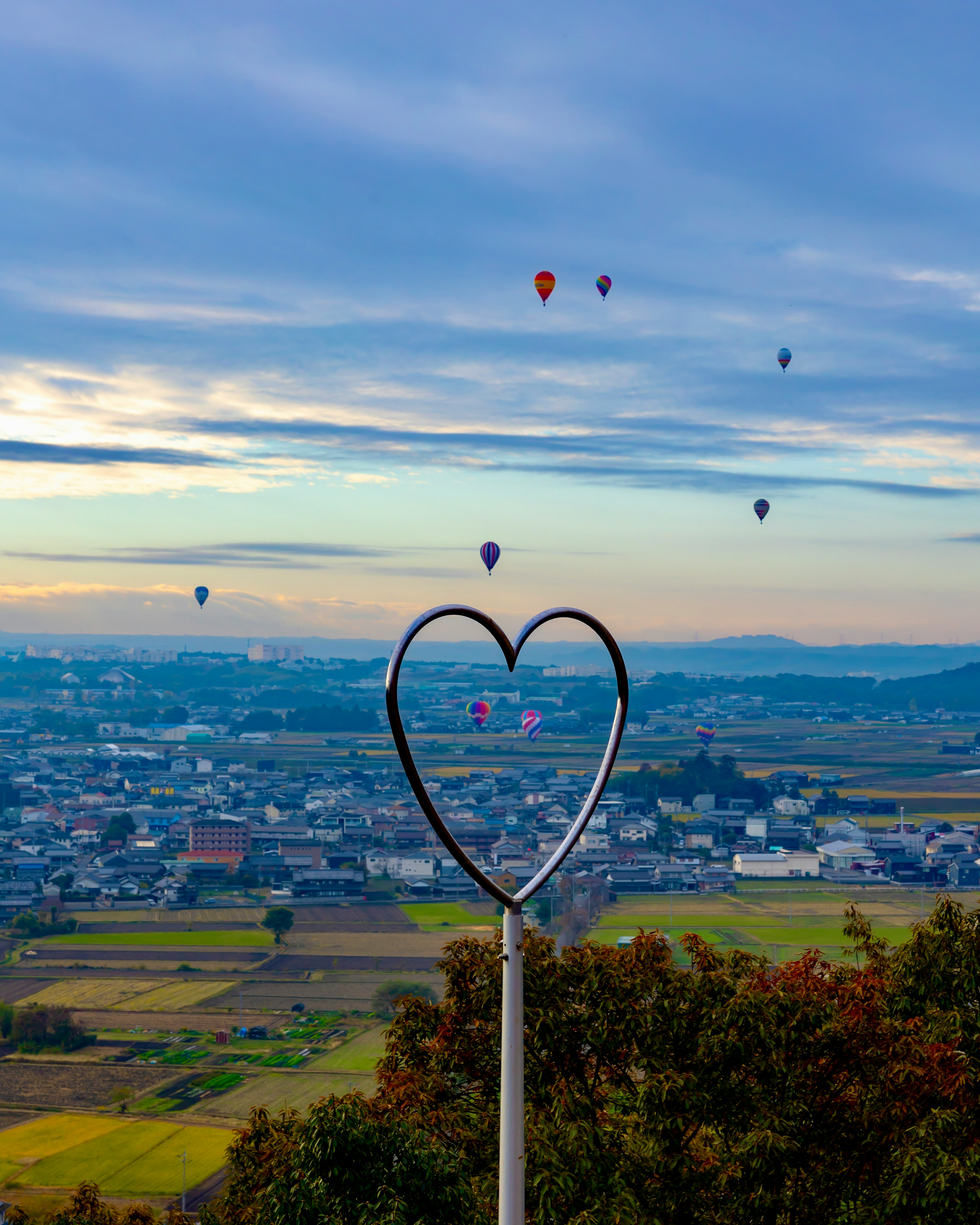 Cornice a forma di cuore con mongolfiere colorate nel cielo