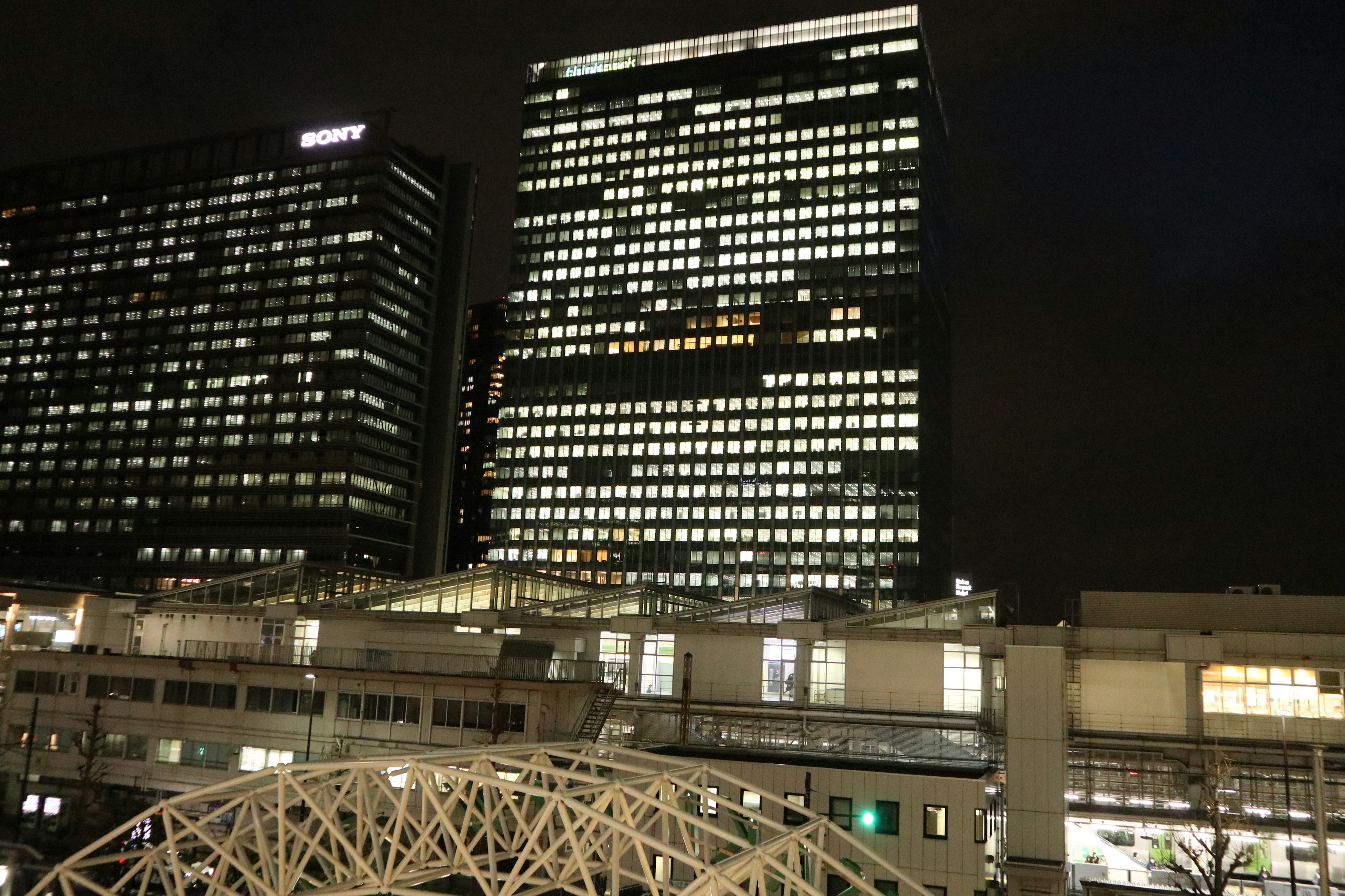 Urban skyline at night with illuminated windows