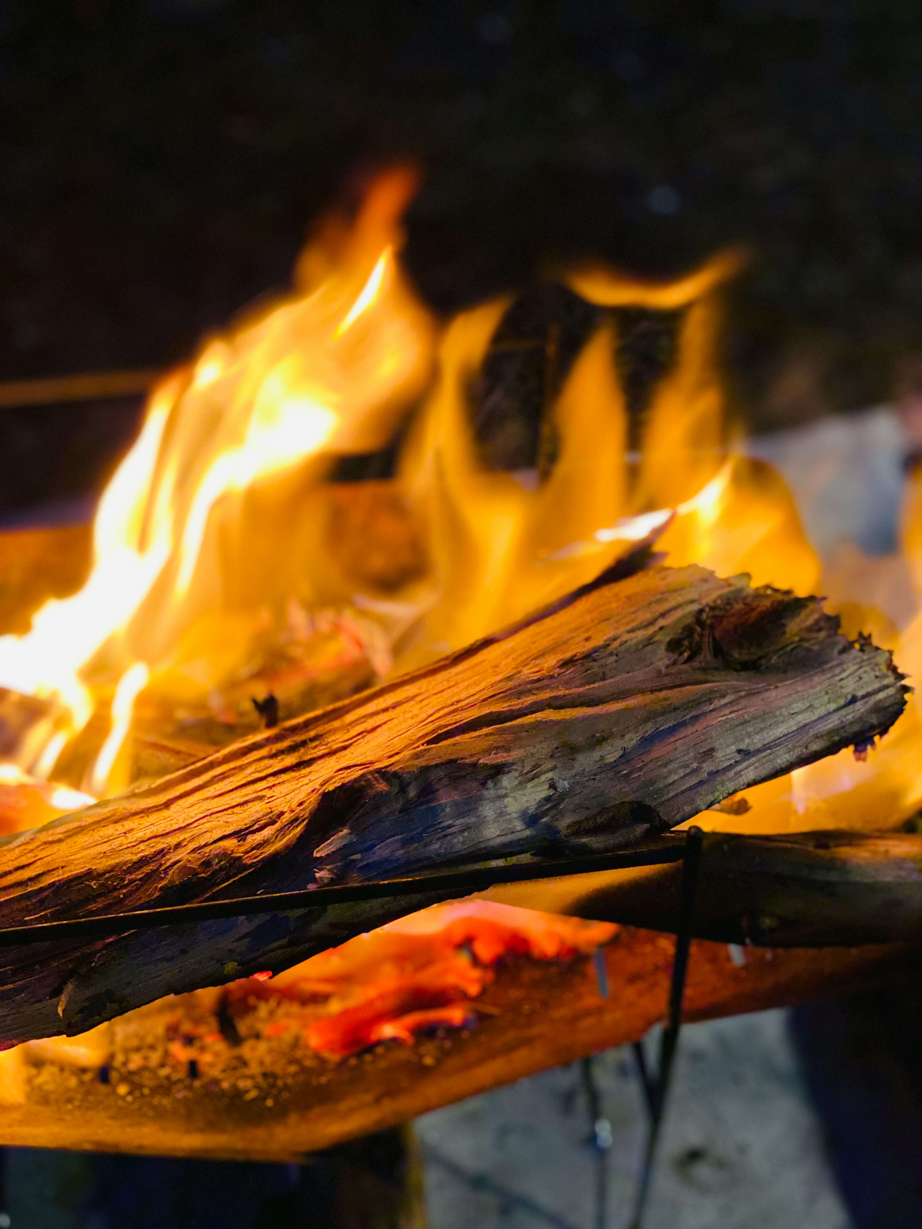 Close-up of flames rising from wooden logs