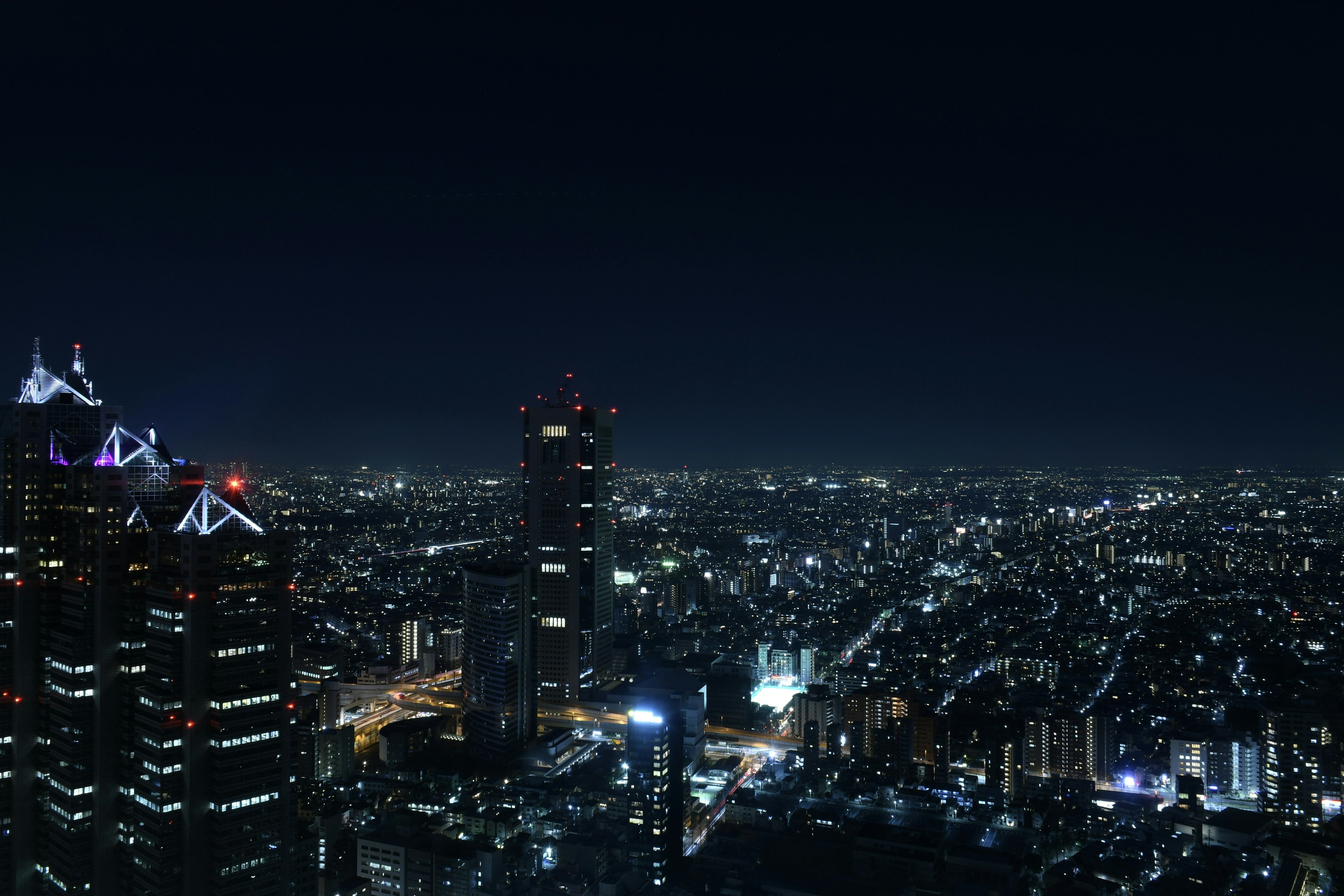 Panoramic night view of a city with illuminated skyscrapers