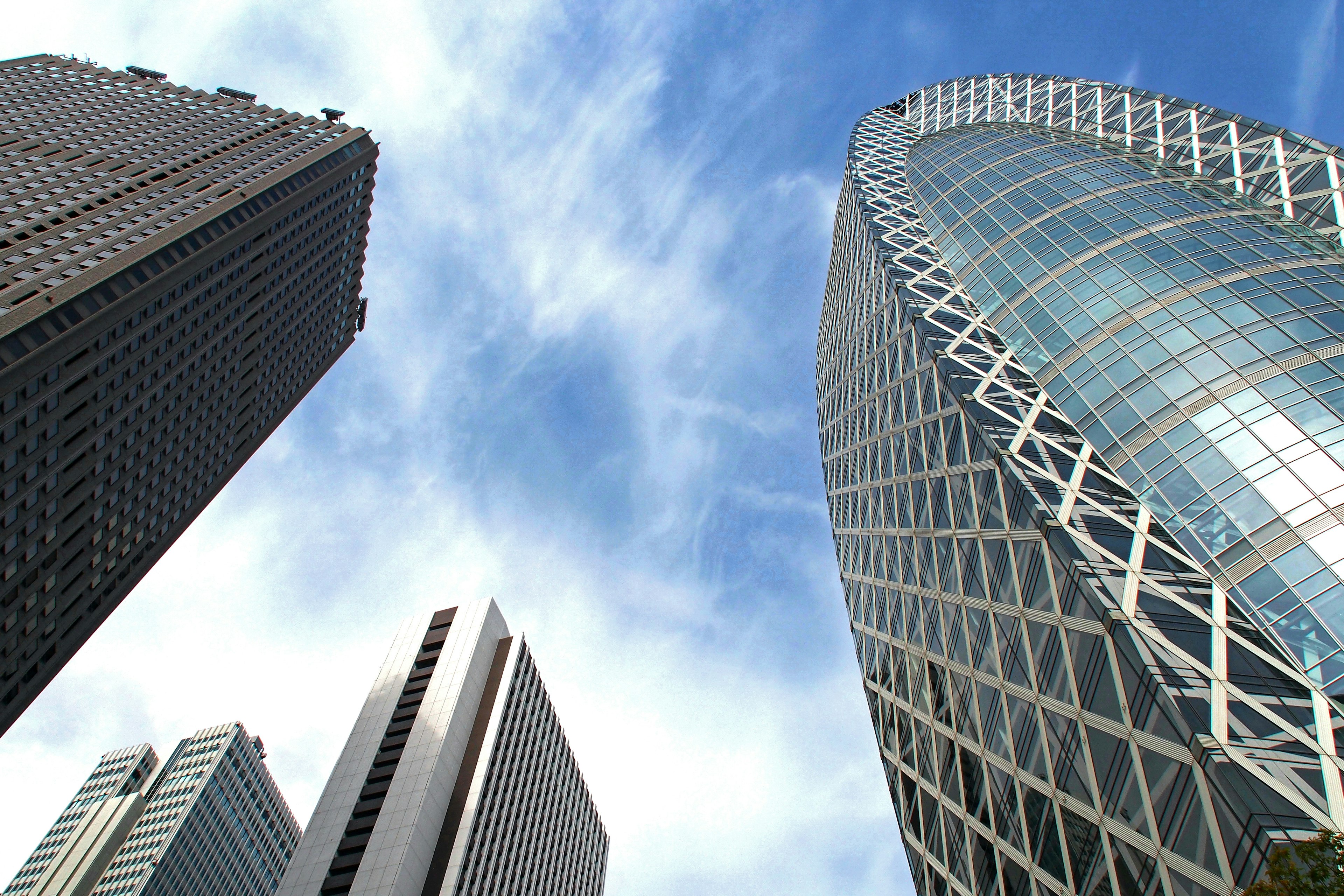 View of modern skyscrapers and blue sky from below