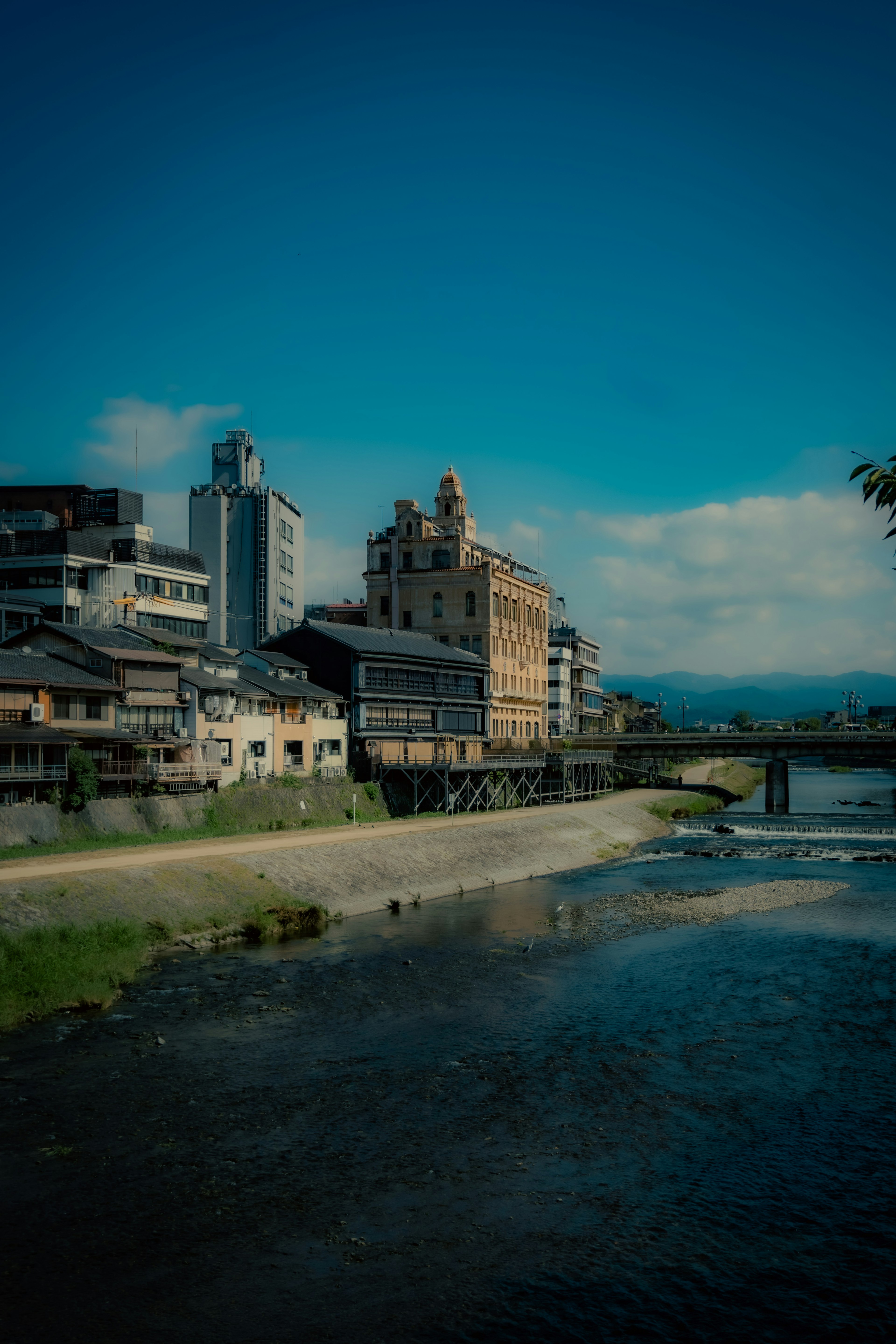 Scenic view of traditional and modern buildings along a river