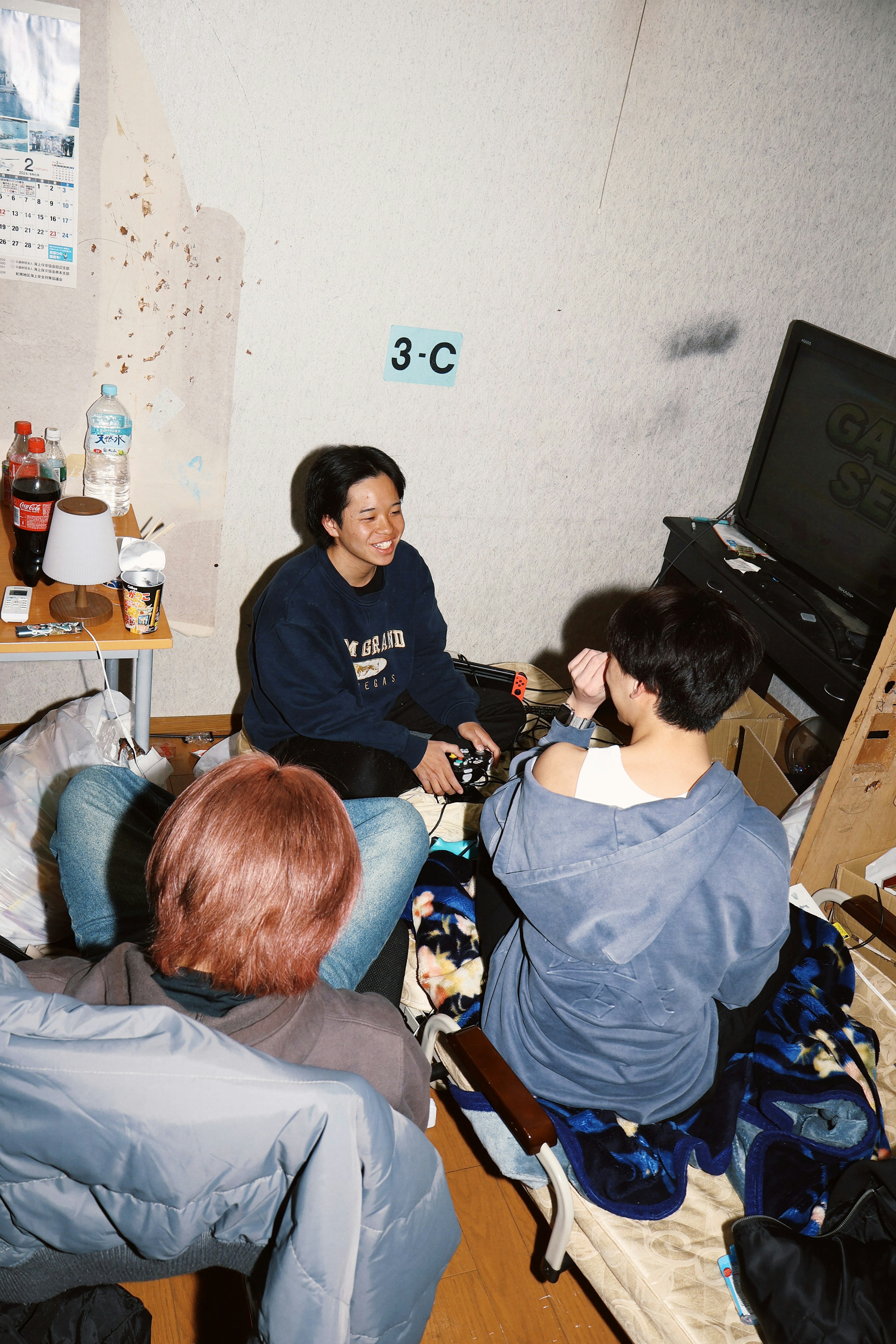 Group of people sitting in a room with a television