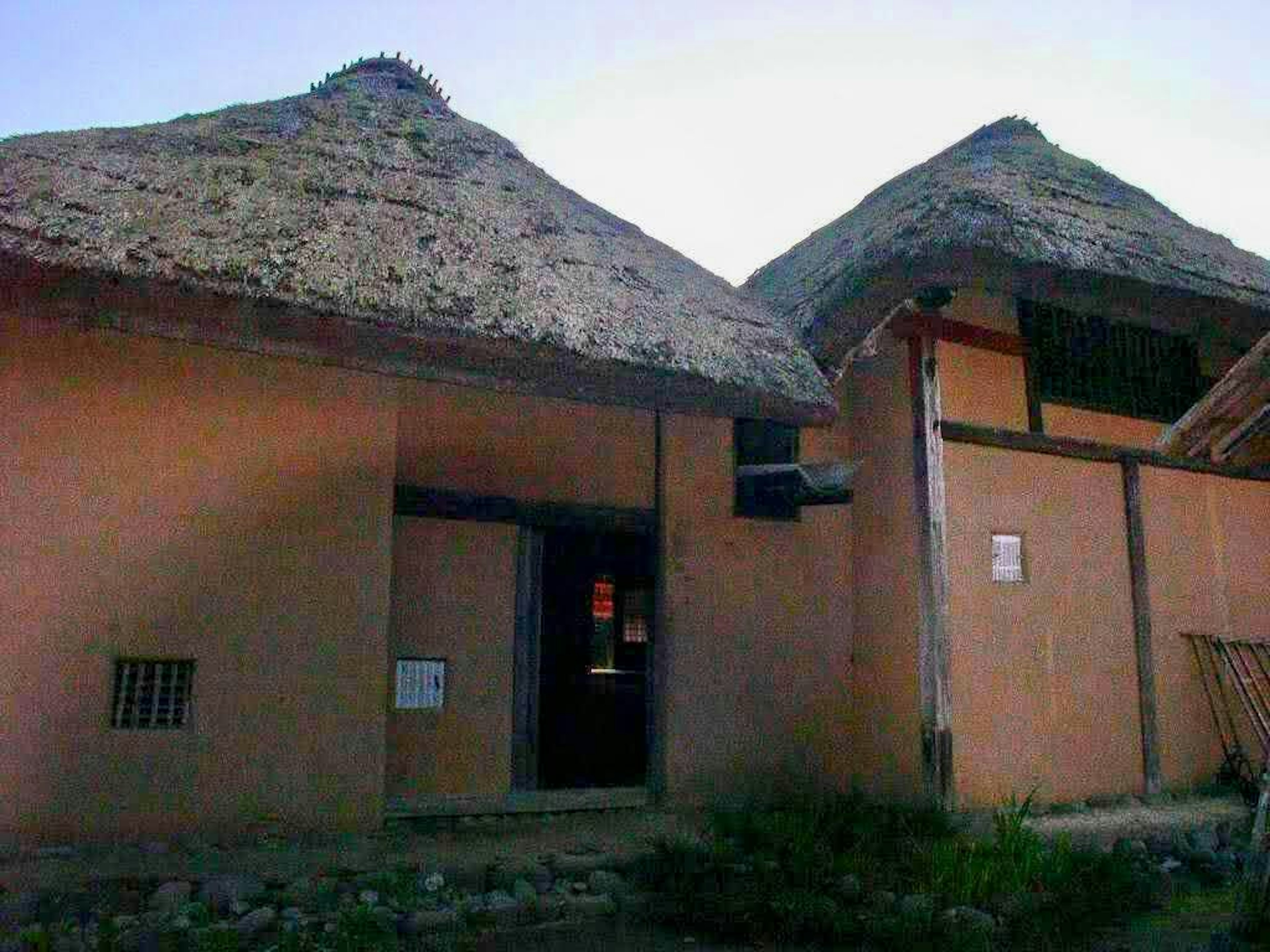 Exterior view of traditional houses with thatched roofs