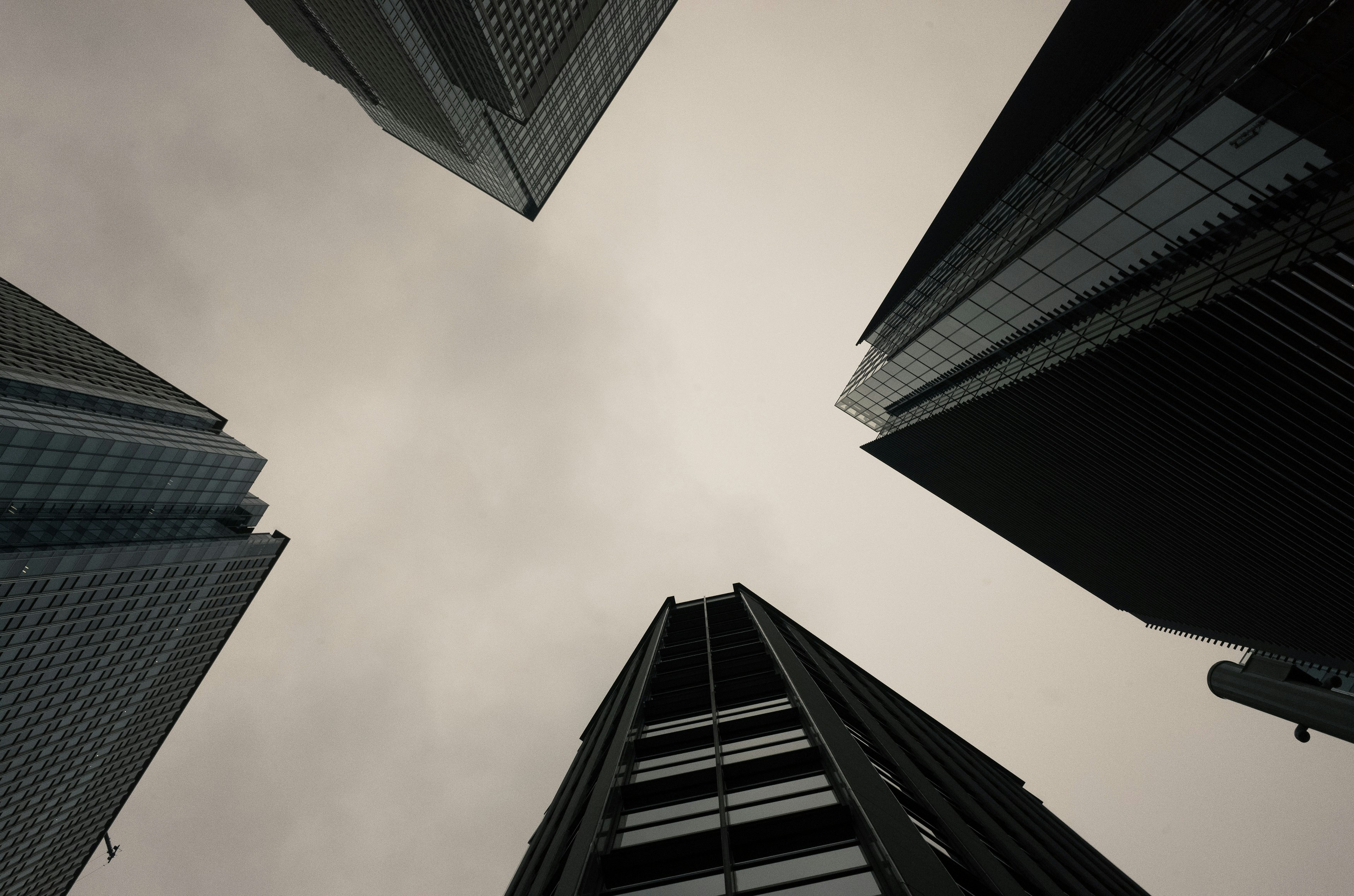 Vista de un cielo nublado desde el suelo entre edificios altos