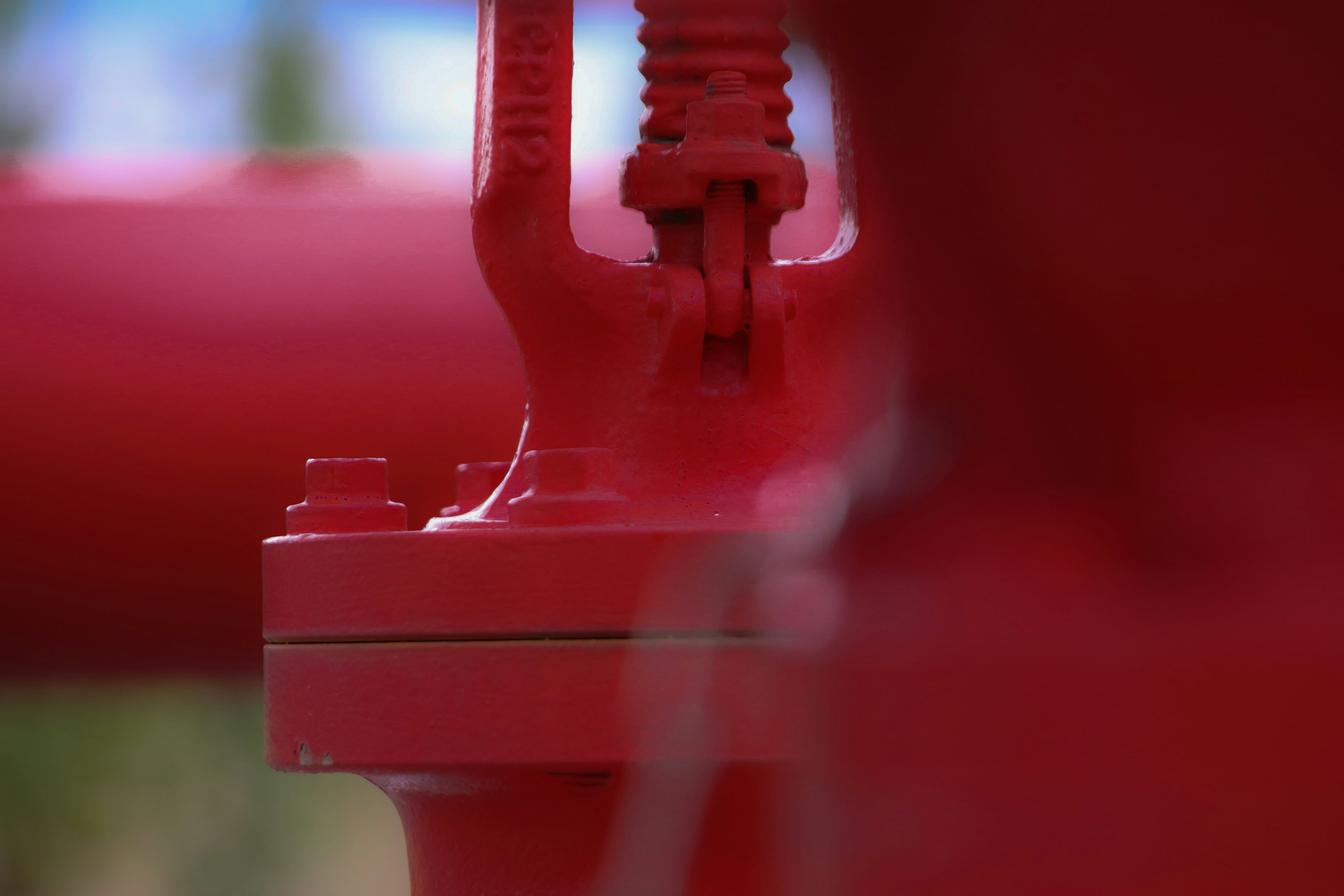 Close-up image of a red pipe and valve