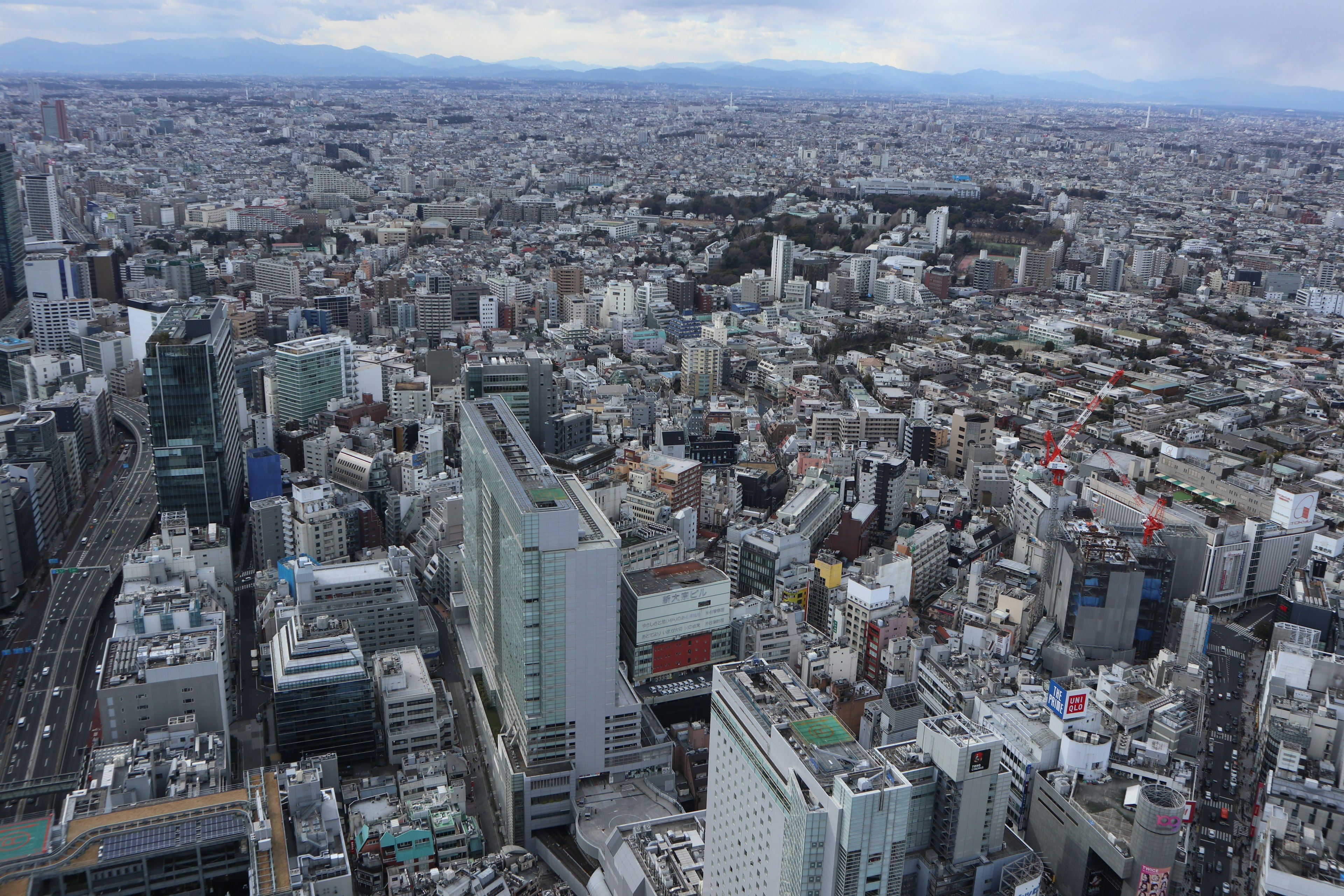 Aerial view of a vast urban landscape showing clusters of buildings and roads