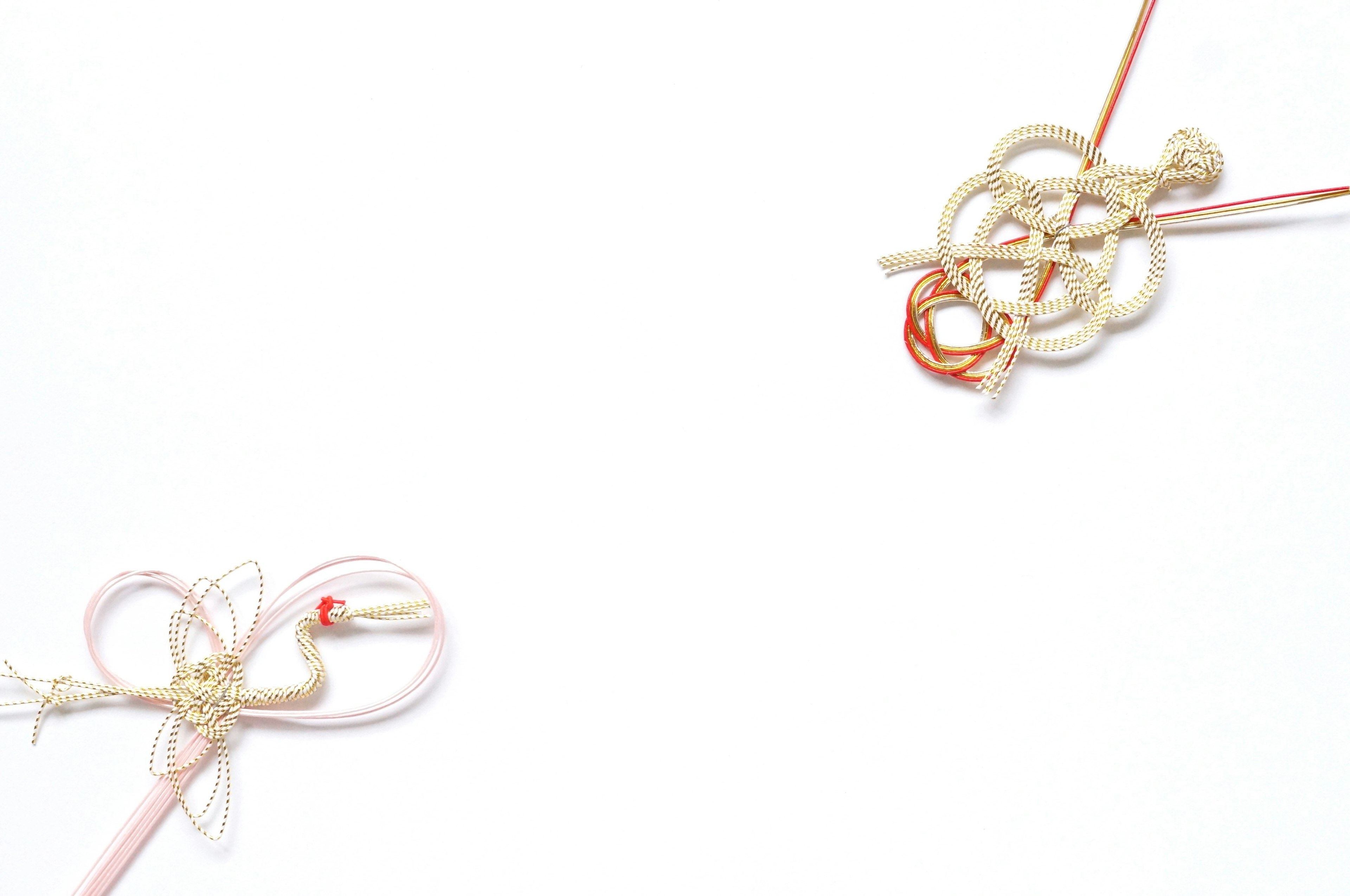 Two traditional Japanese knots displayed on a white background