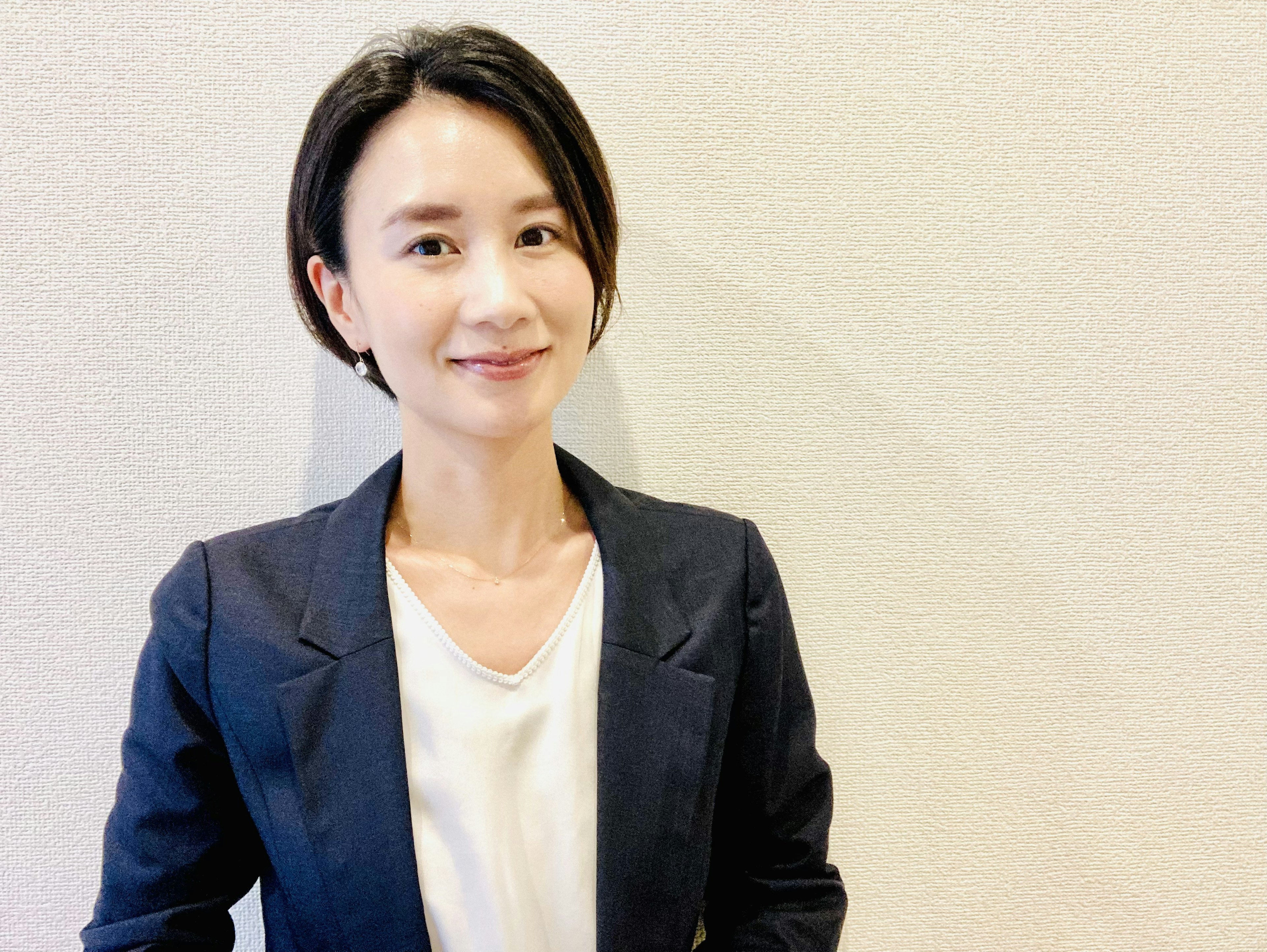 A smiling woman in a business suit