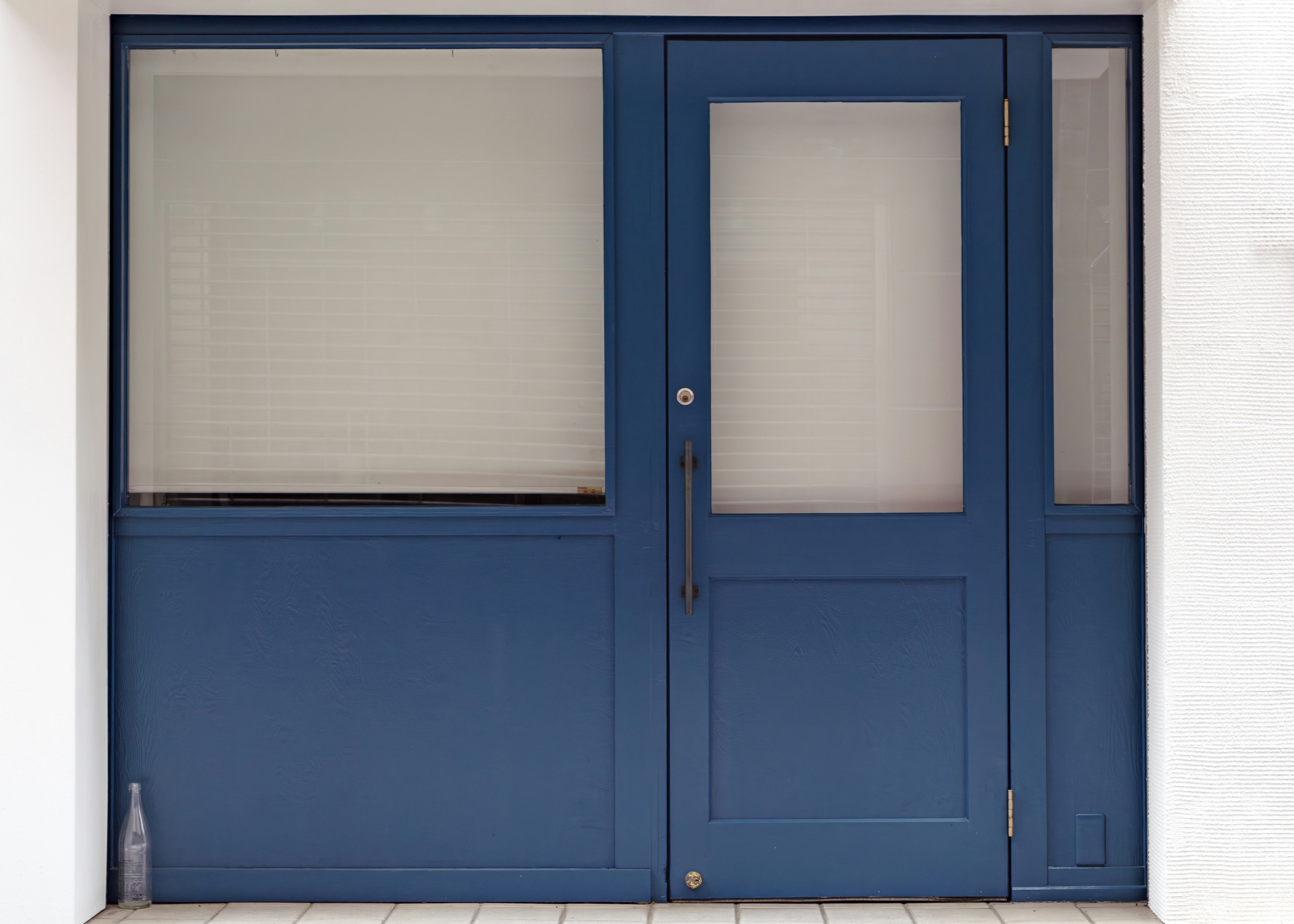 Simple entrance with blue door and glass windows