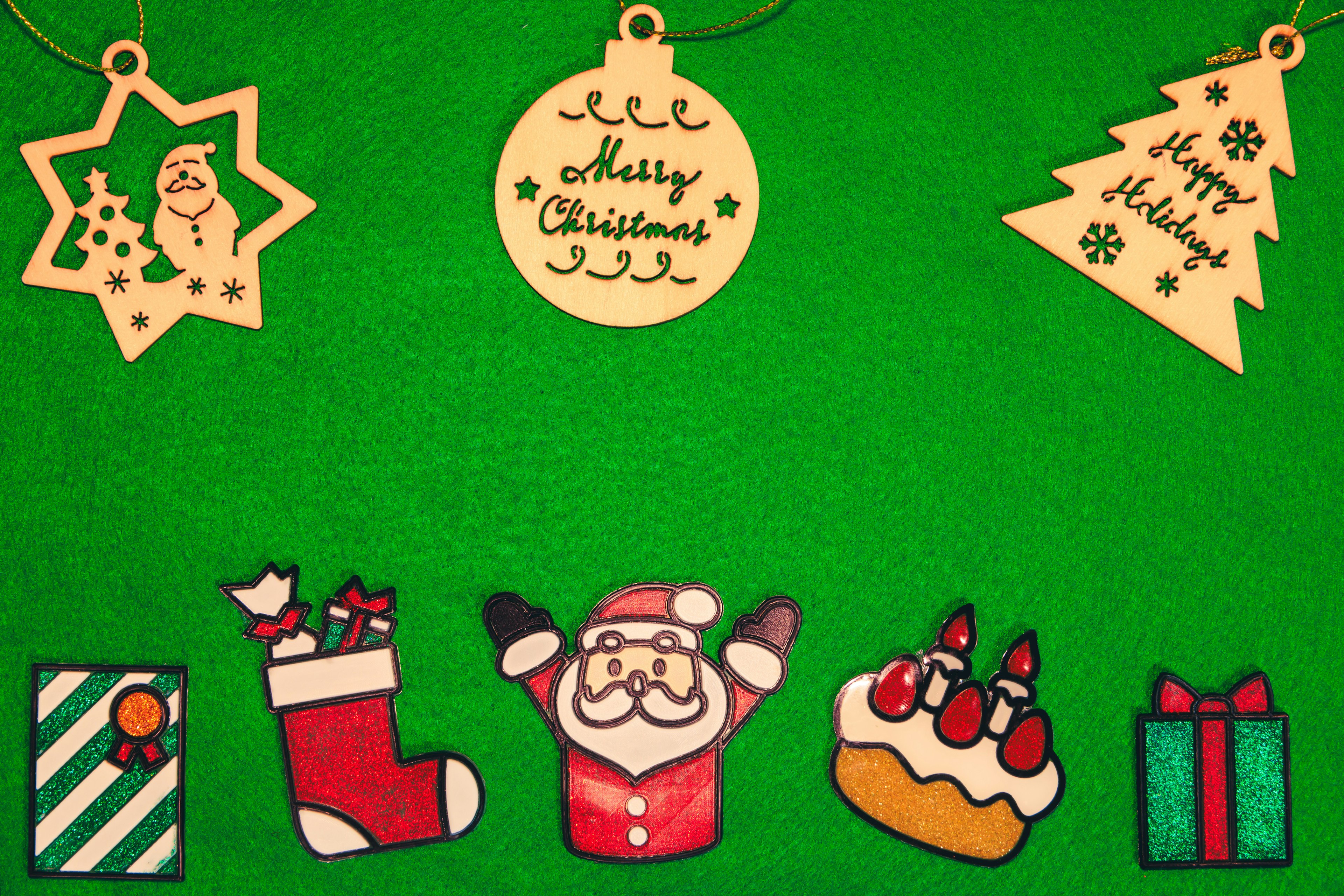 Image featuring Christmas decorations and treats on a green background