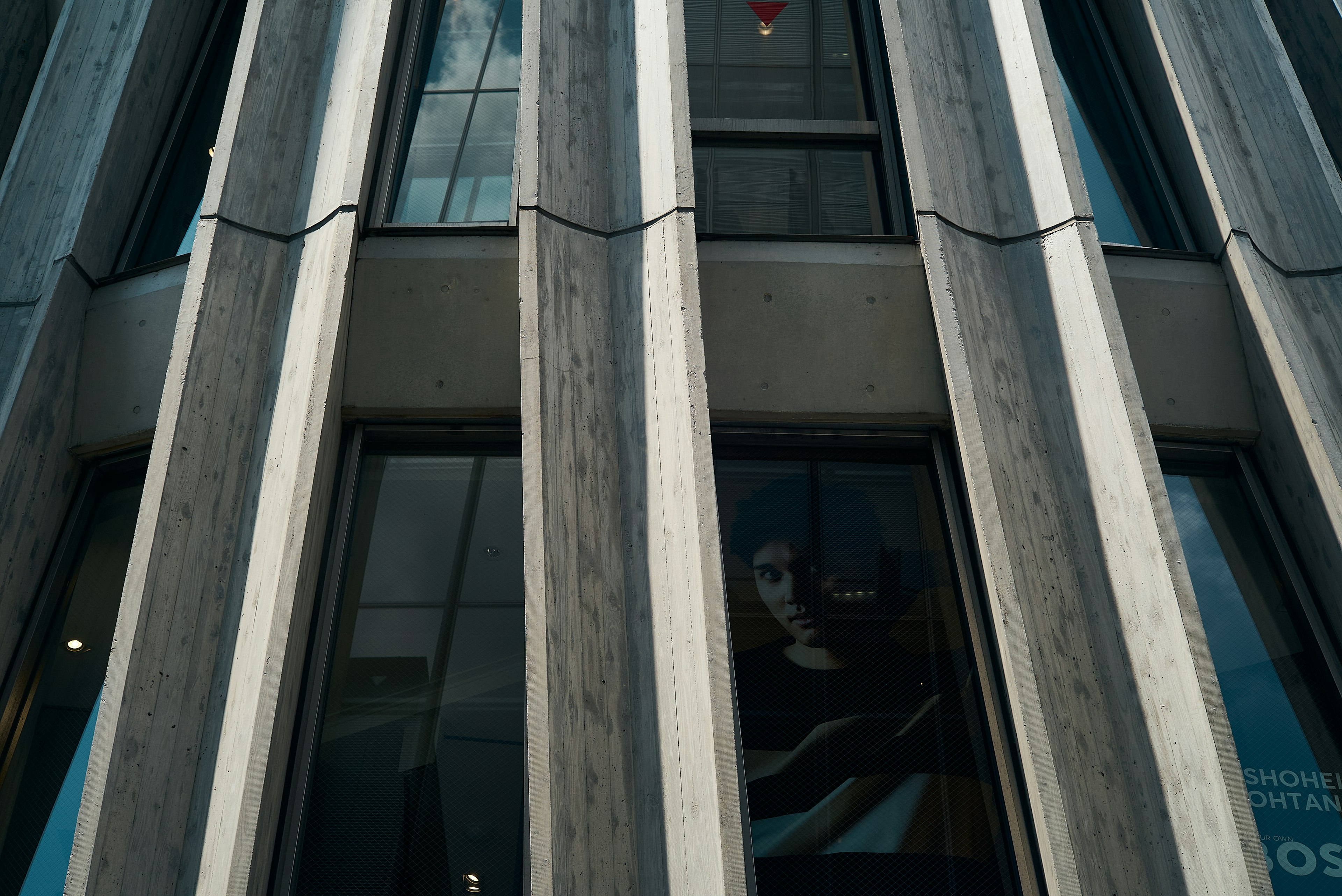 Modern building facade with vertical stripe design window reflections