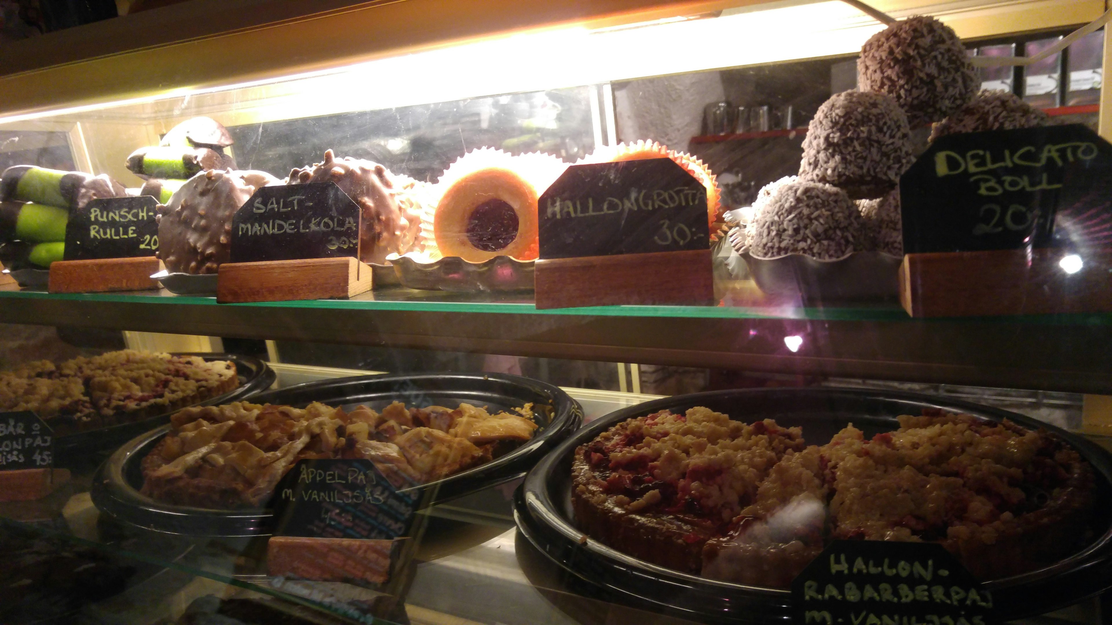 A display case filled with various colorful desserts