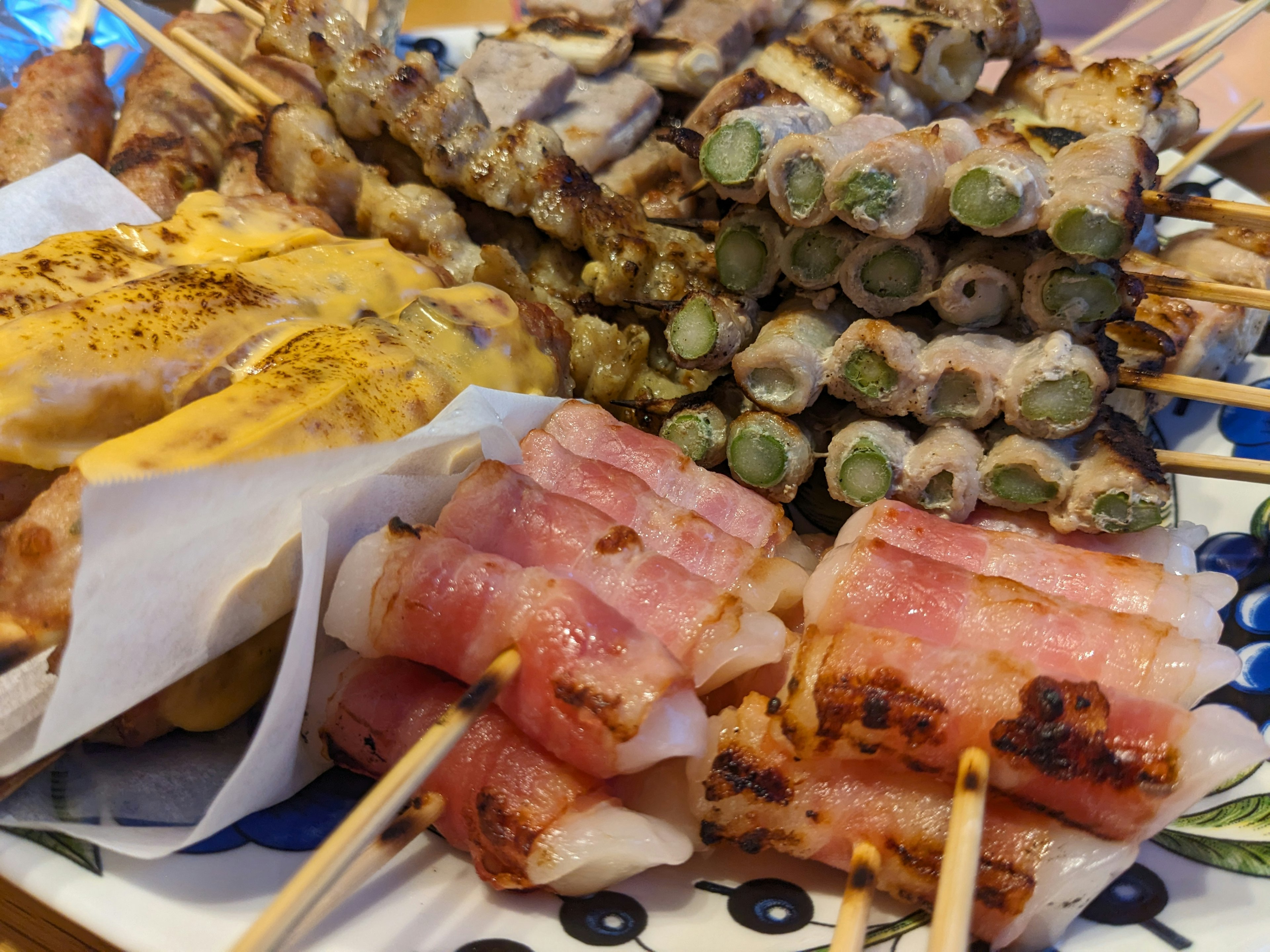 A plate of assorted skewers including grilled chicken and vegetables