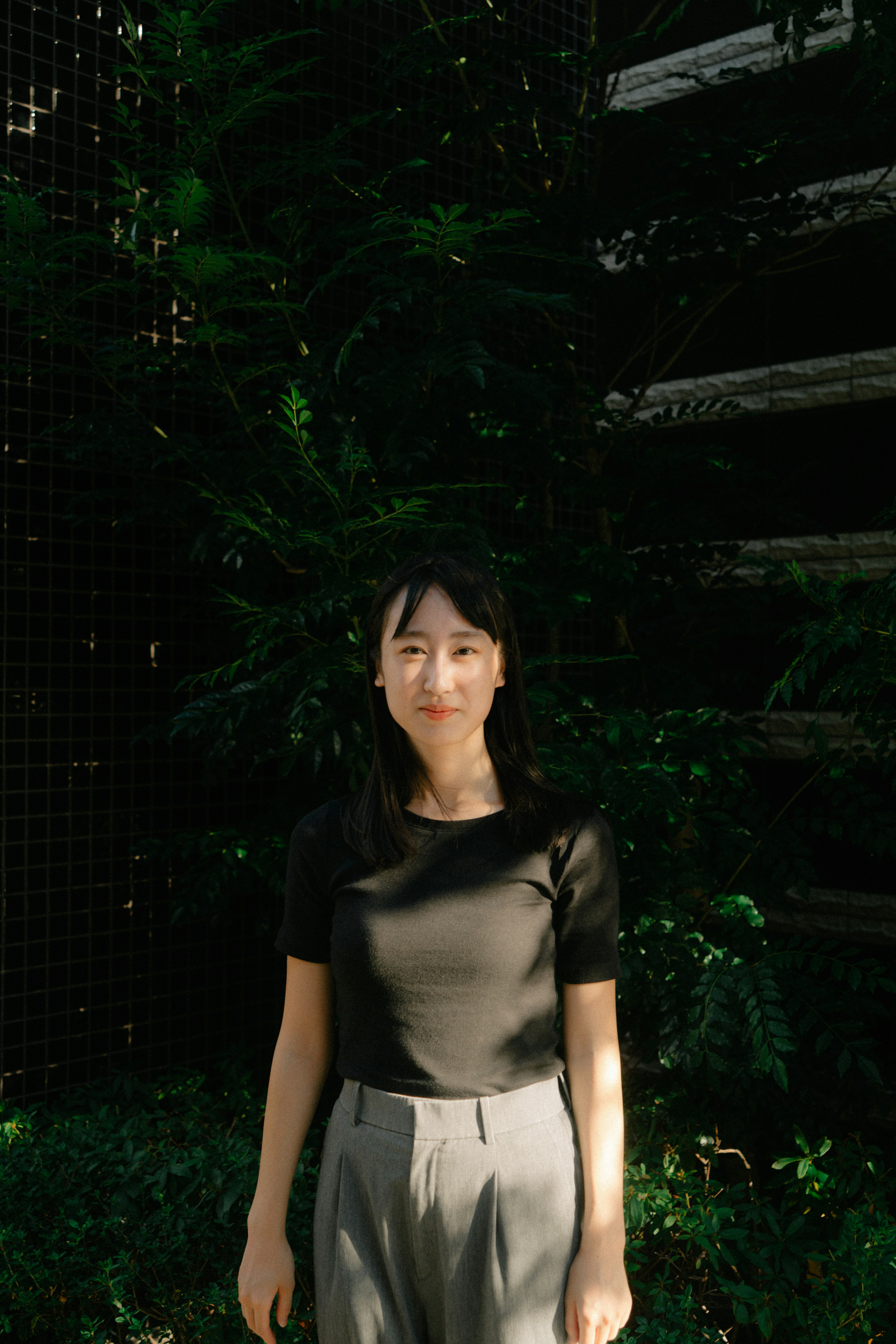 Portrait of a woman standing in front of a green background