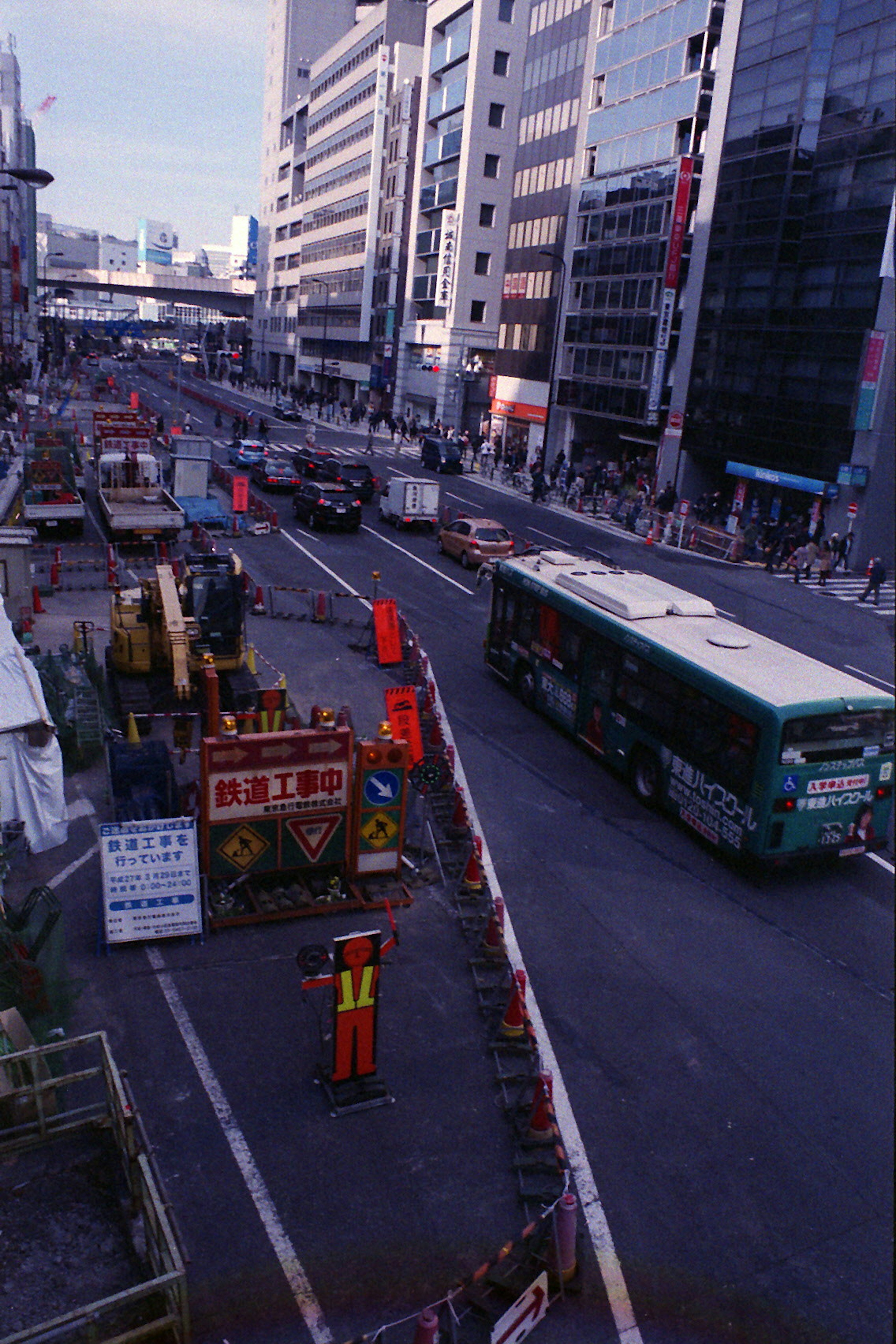 Construction site with a bus on a busy street