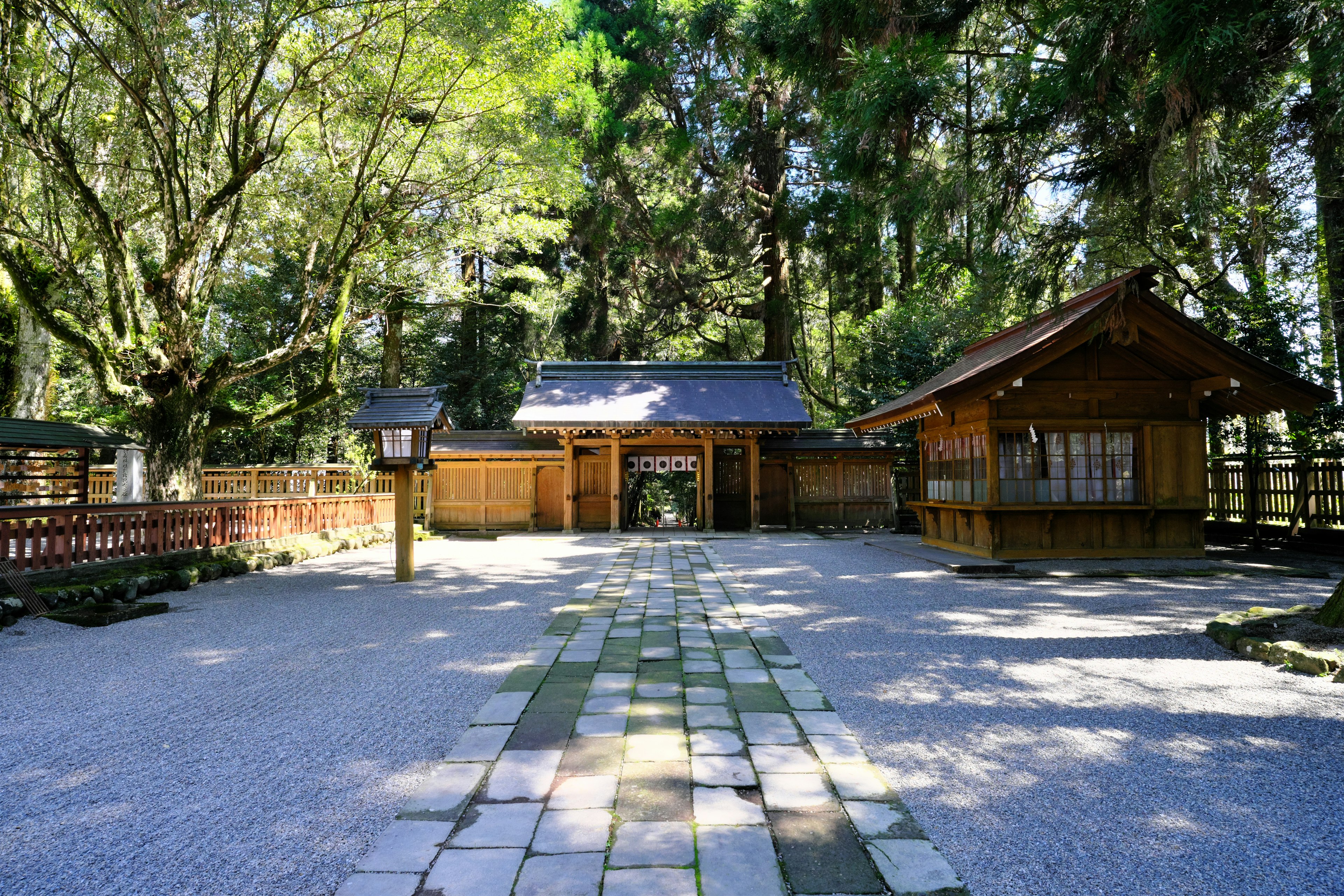 Entrance to a Japanese shrine surrounded by lush greenery