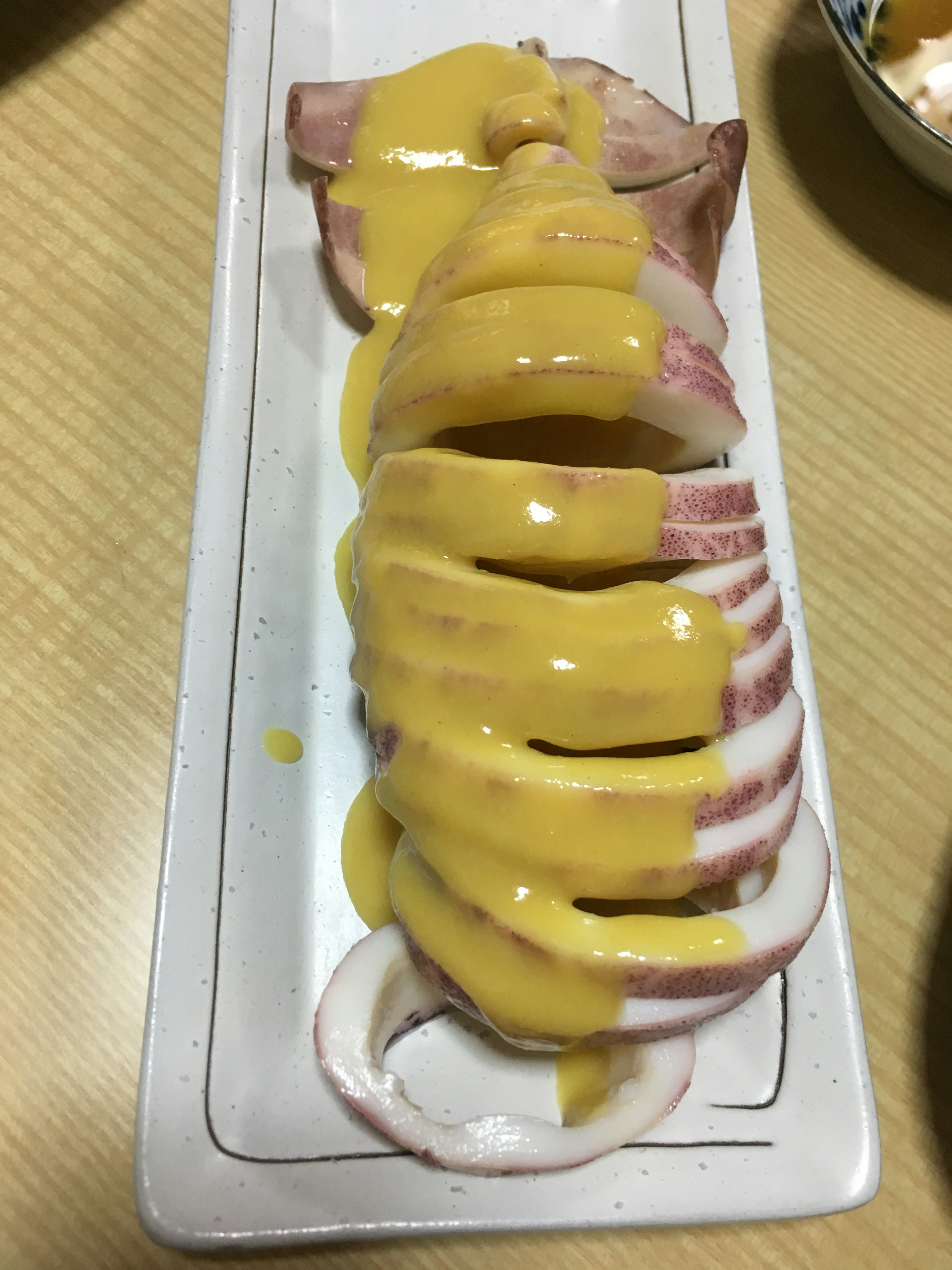 Sliced ham drizzled with mustard sauce