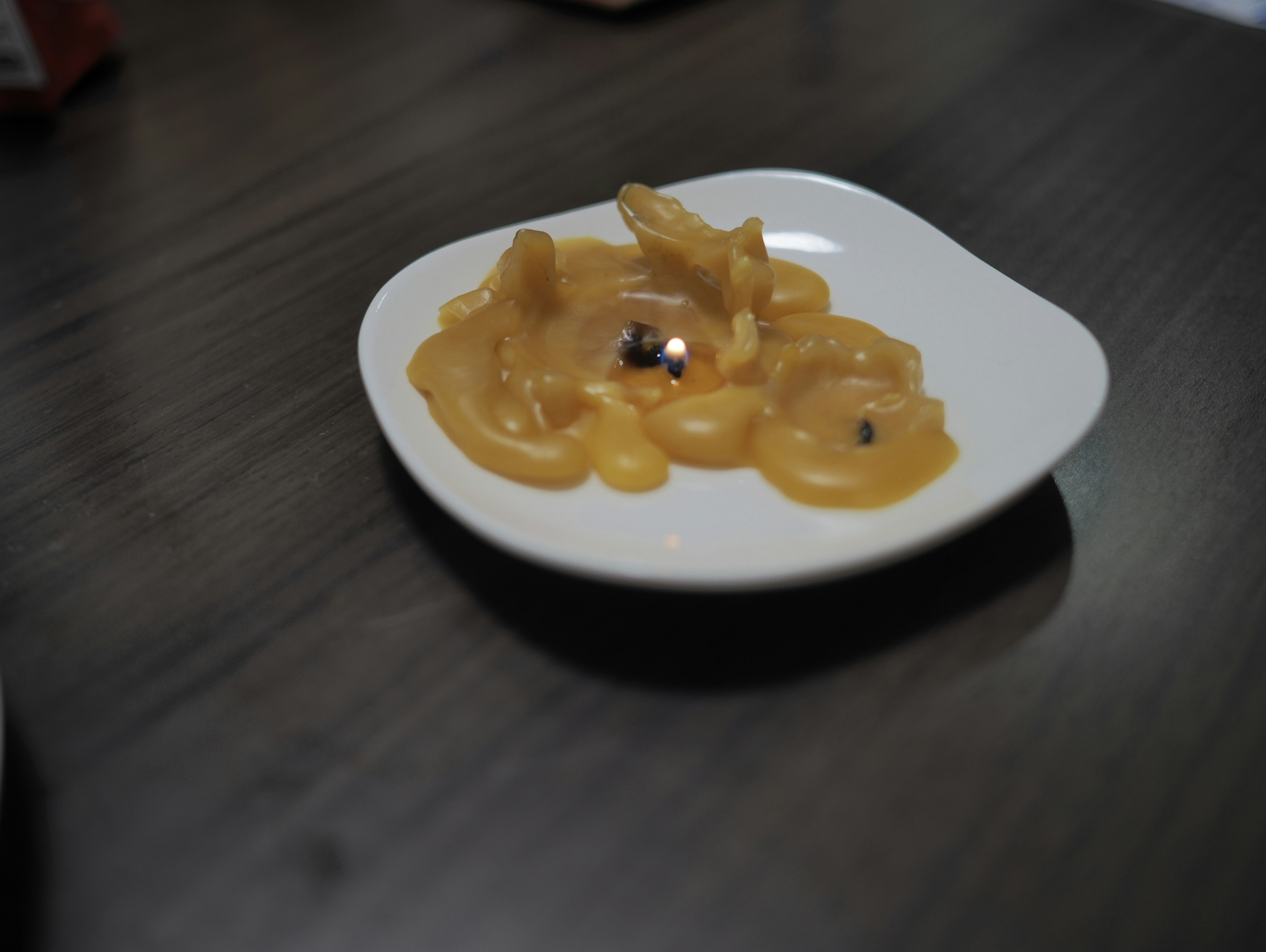 Creamy sauce dish on a white plate with black specks