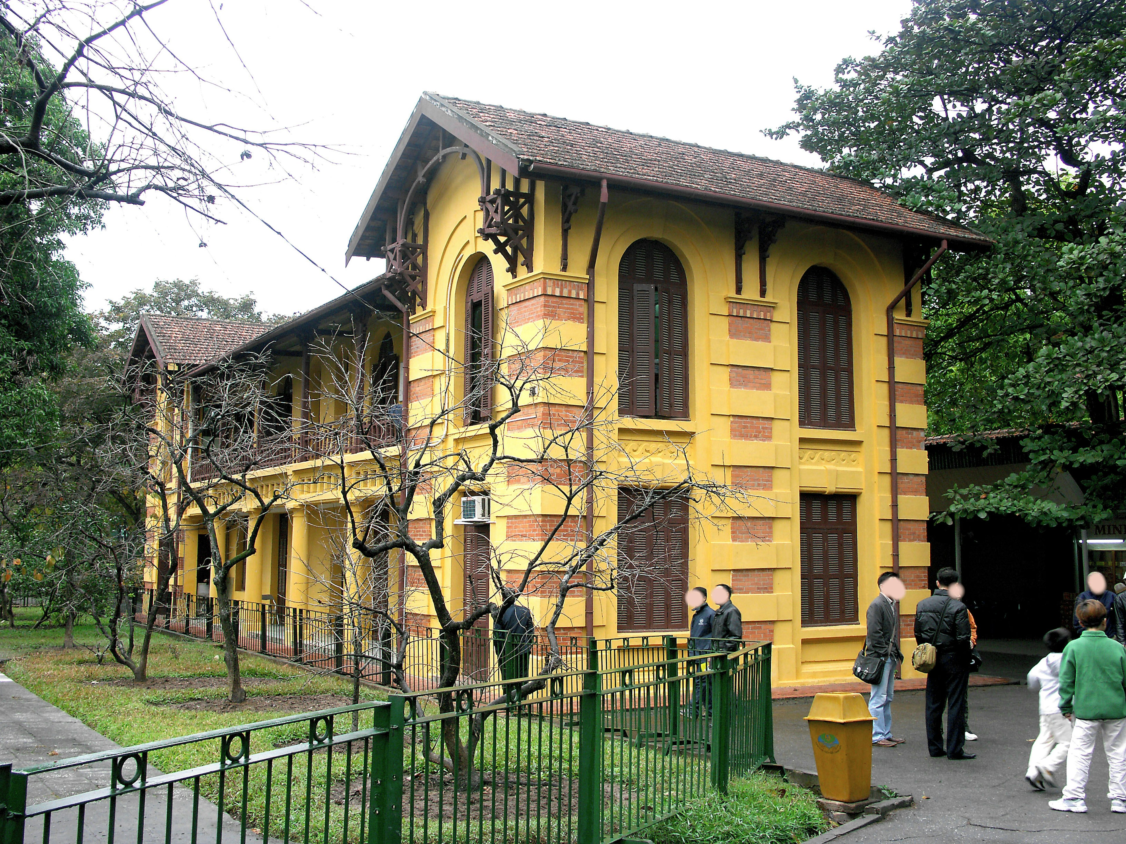 Historic yellow building with green park surroundings