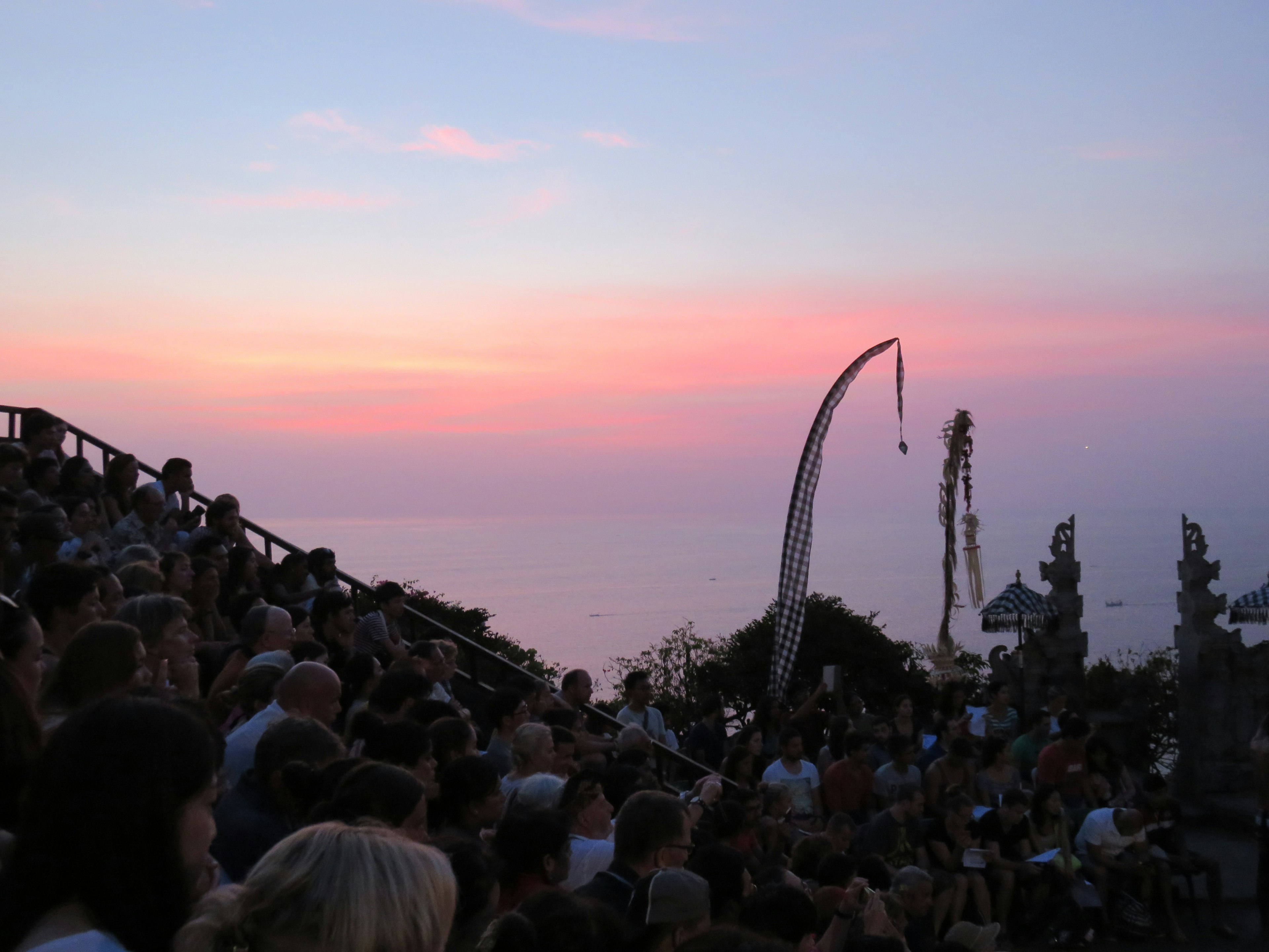 Audience gathered against a sunset sky