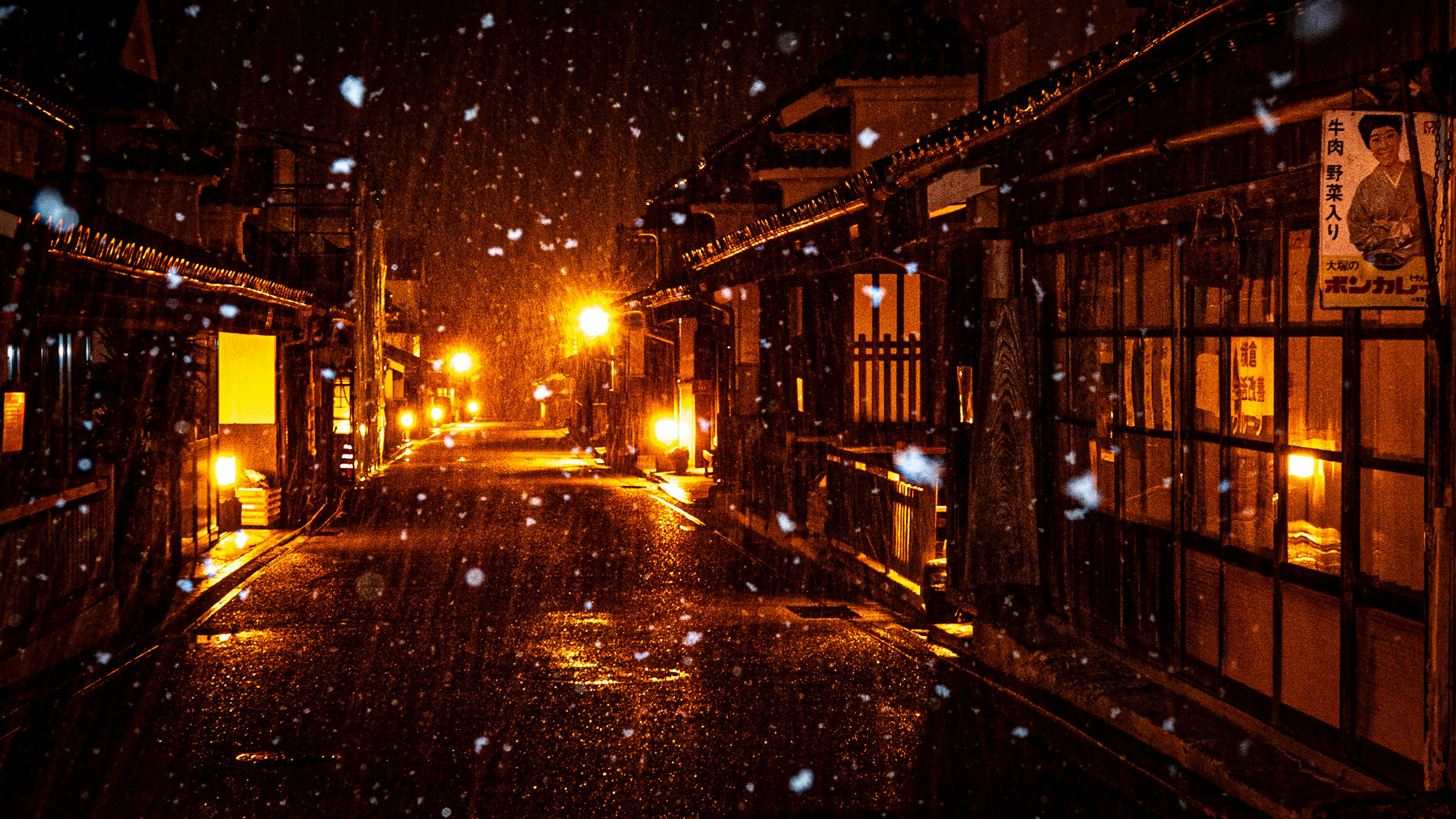 Old street scene at night with falling snow illuminated by streetlights