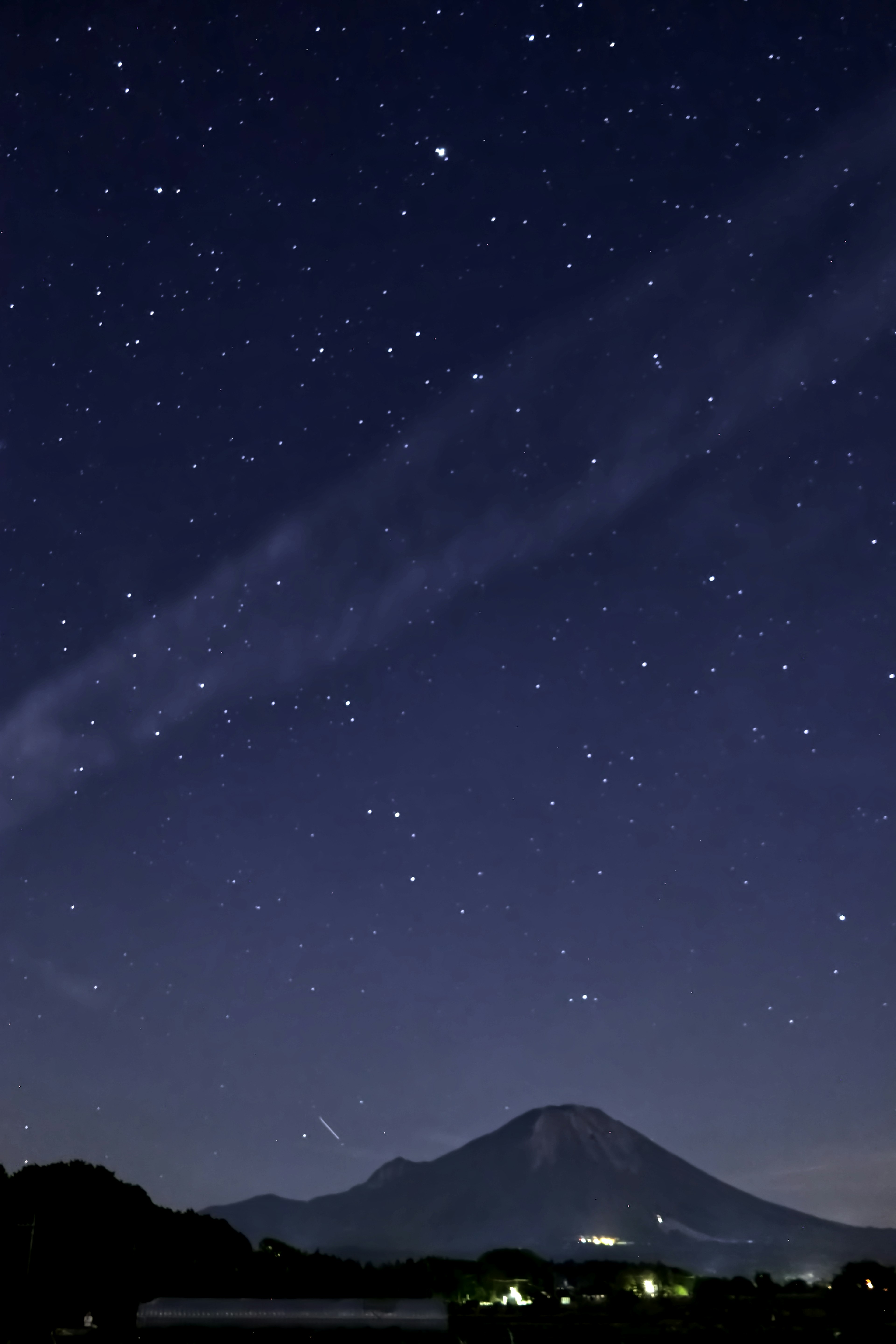 Starry night sky with a mountain silhouette