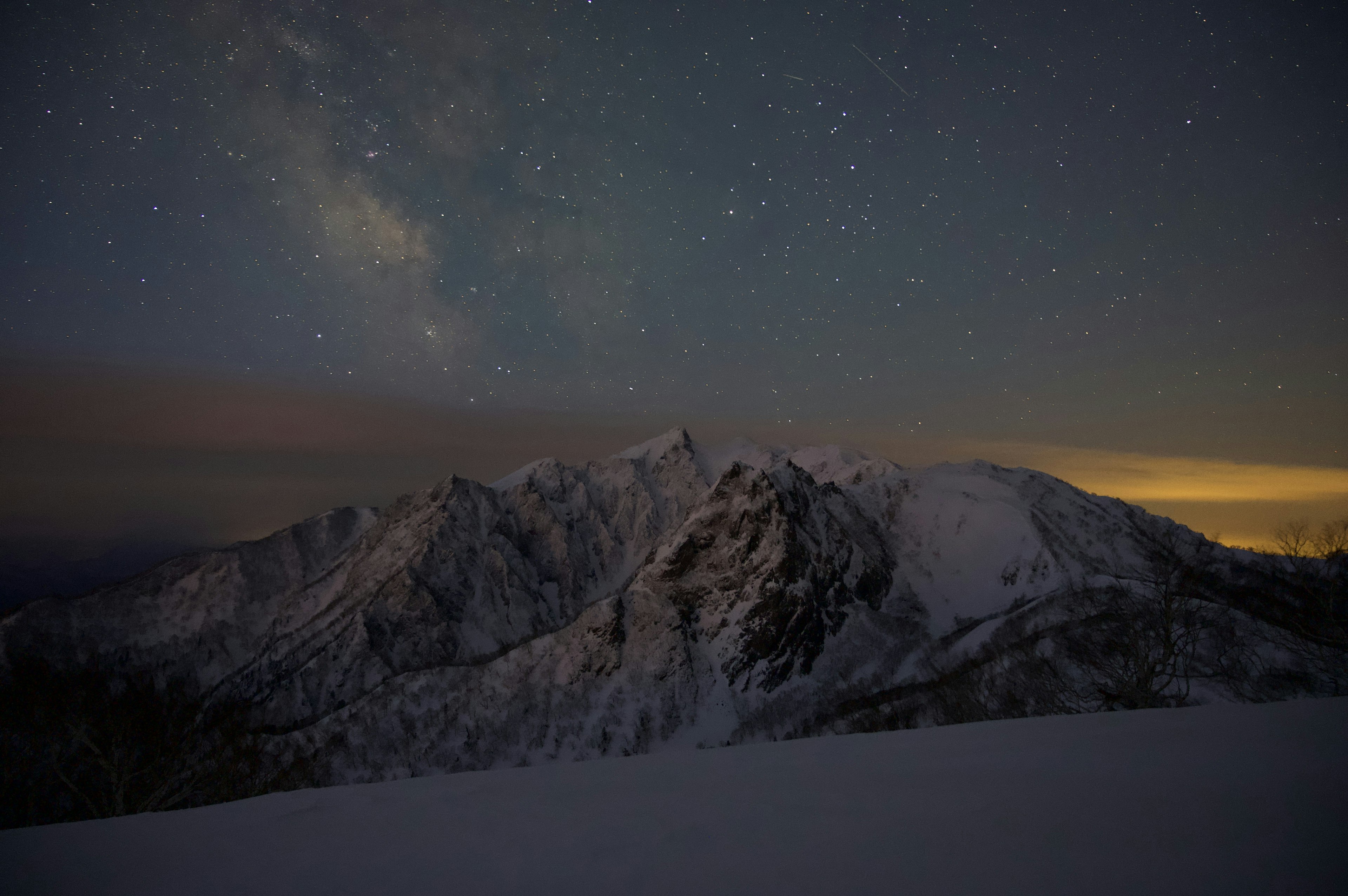 Snow-covered mountains under a starry sky