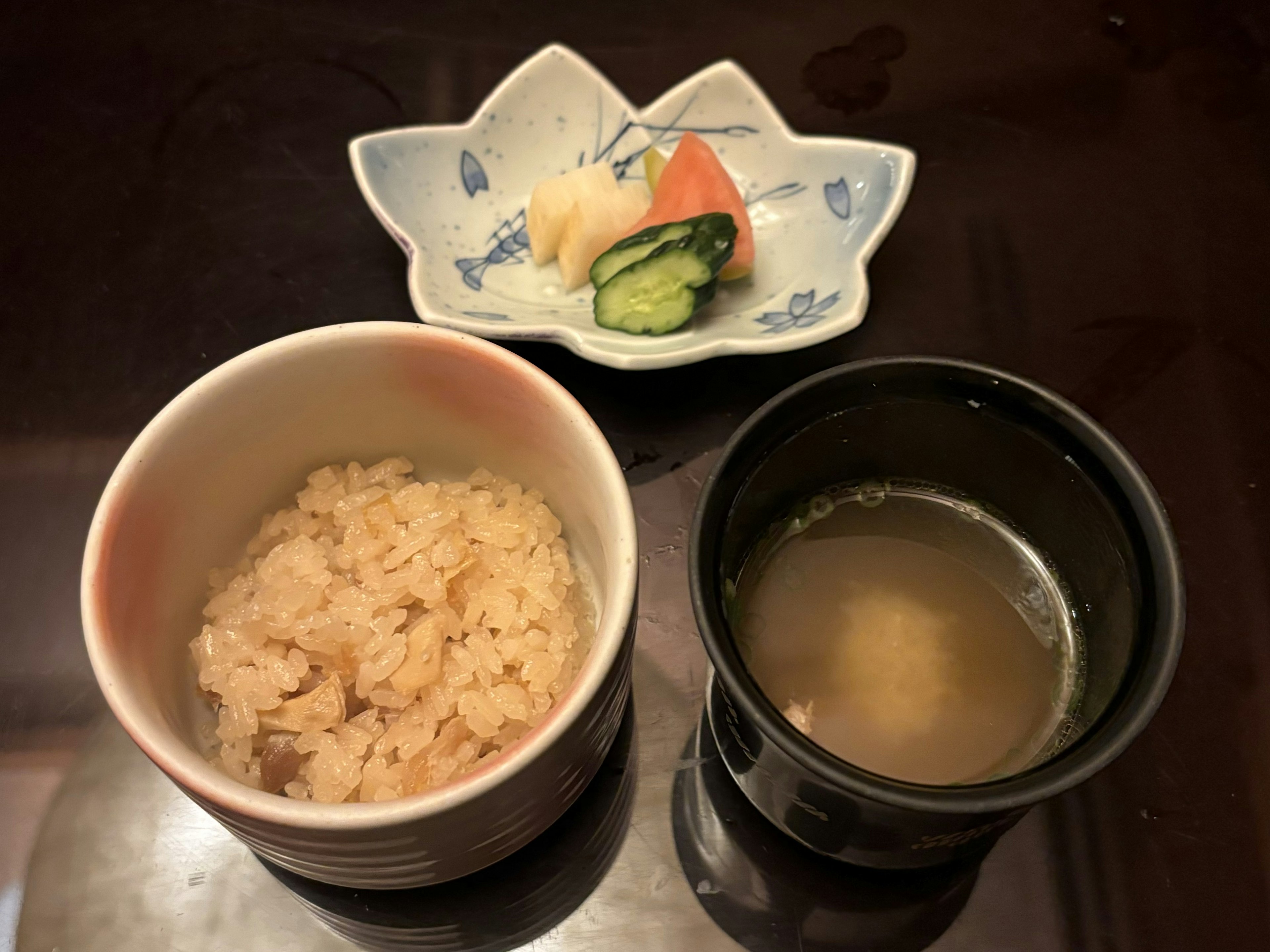 Bowl of white rice with miso soup and a small dish of vegetables