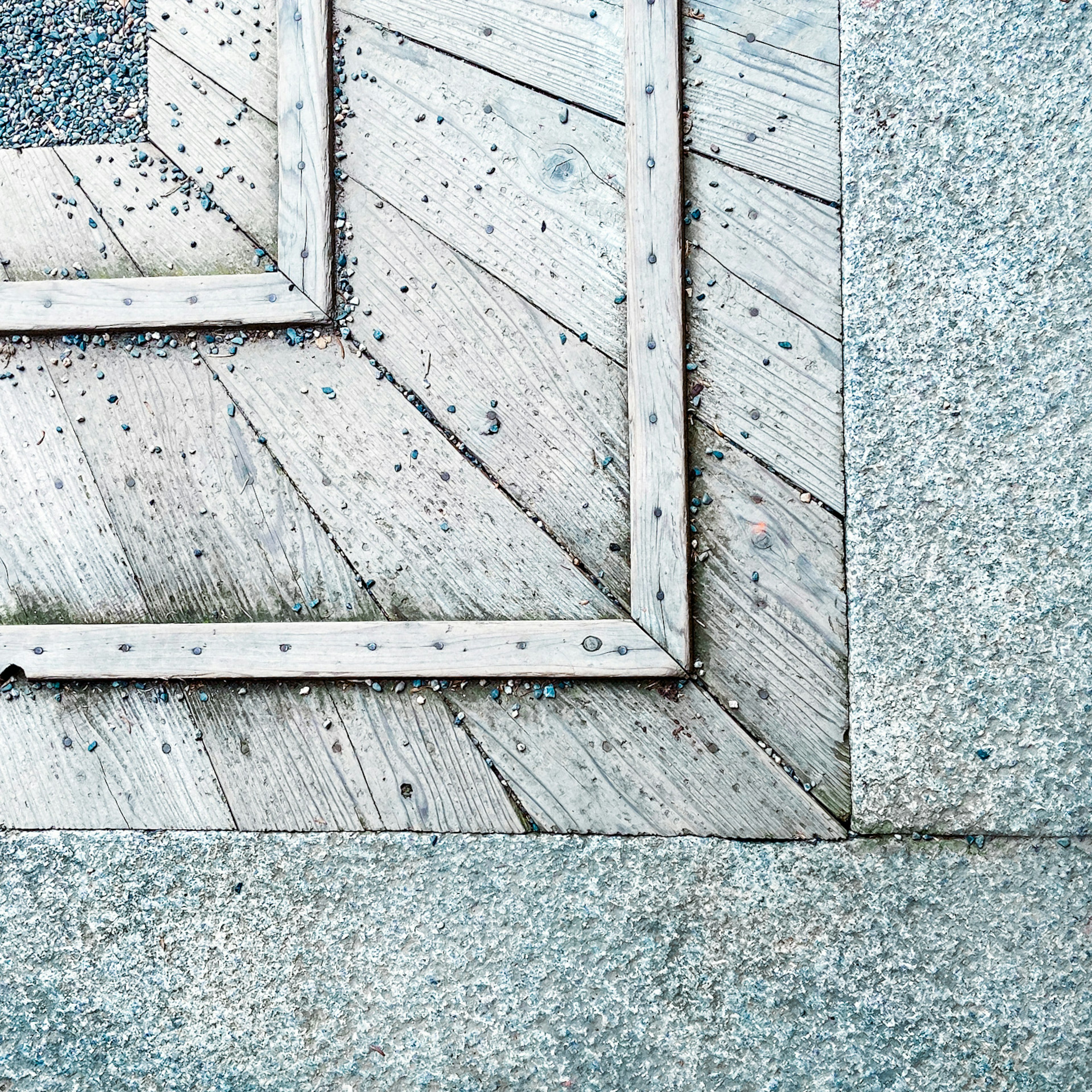 Close-up of a geometric patterned floor with wooden frames