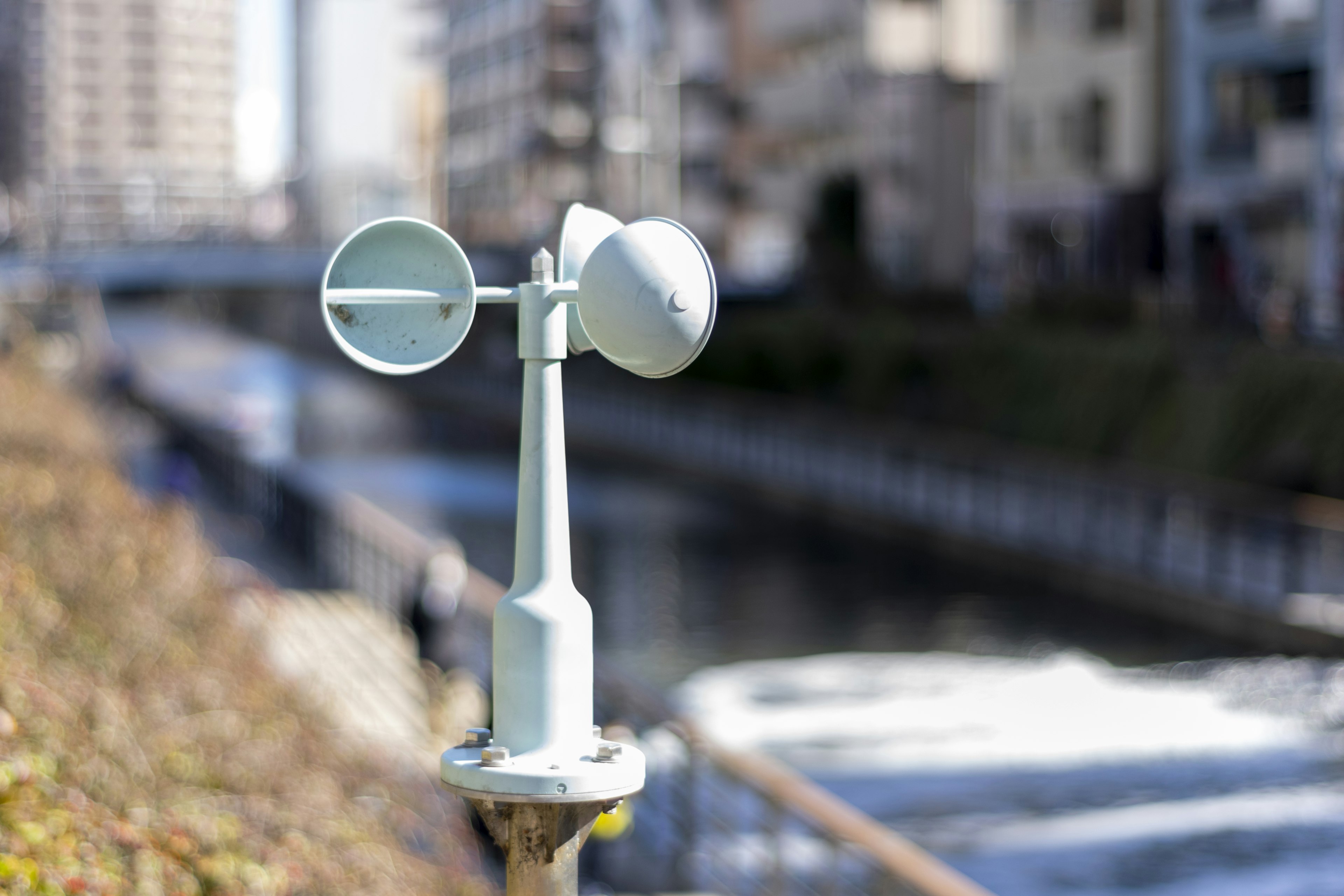 Close-up of a weather monitoring device near a waterway