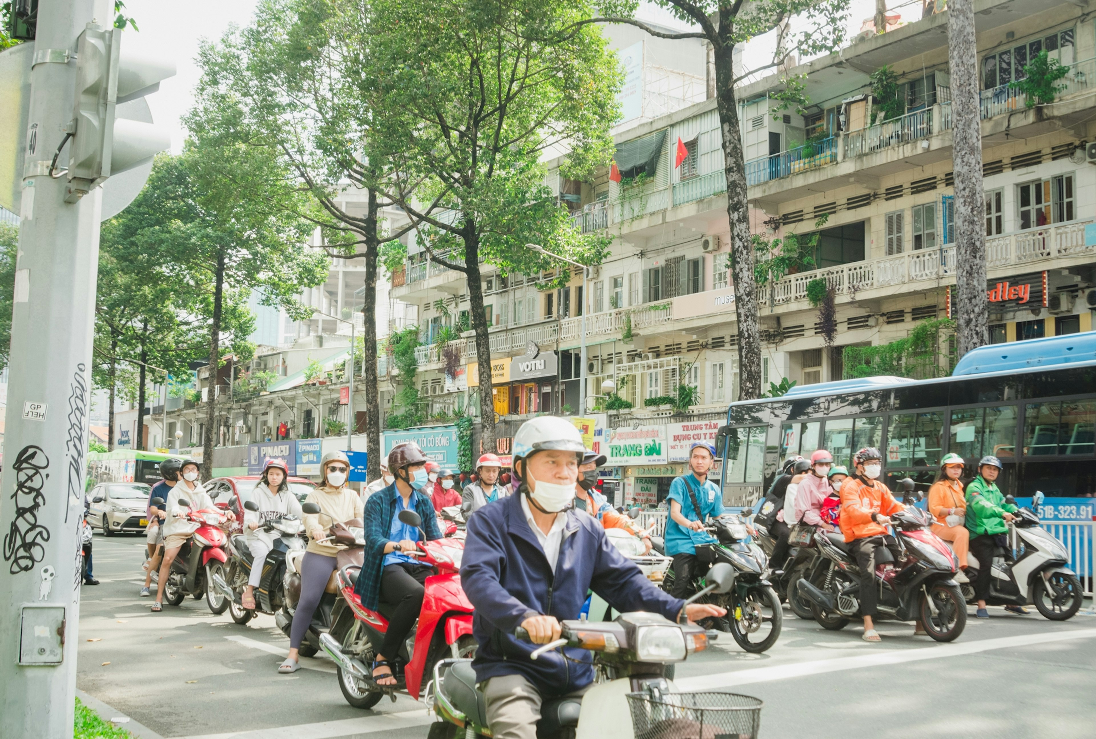 Traffic scene with multiple motorcyclists waiting at an intersection