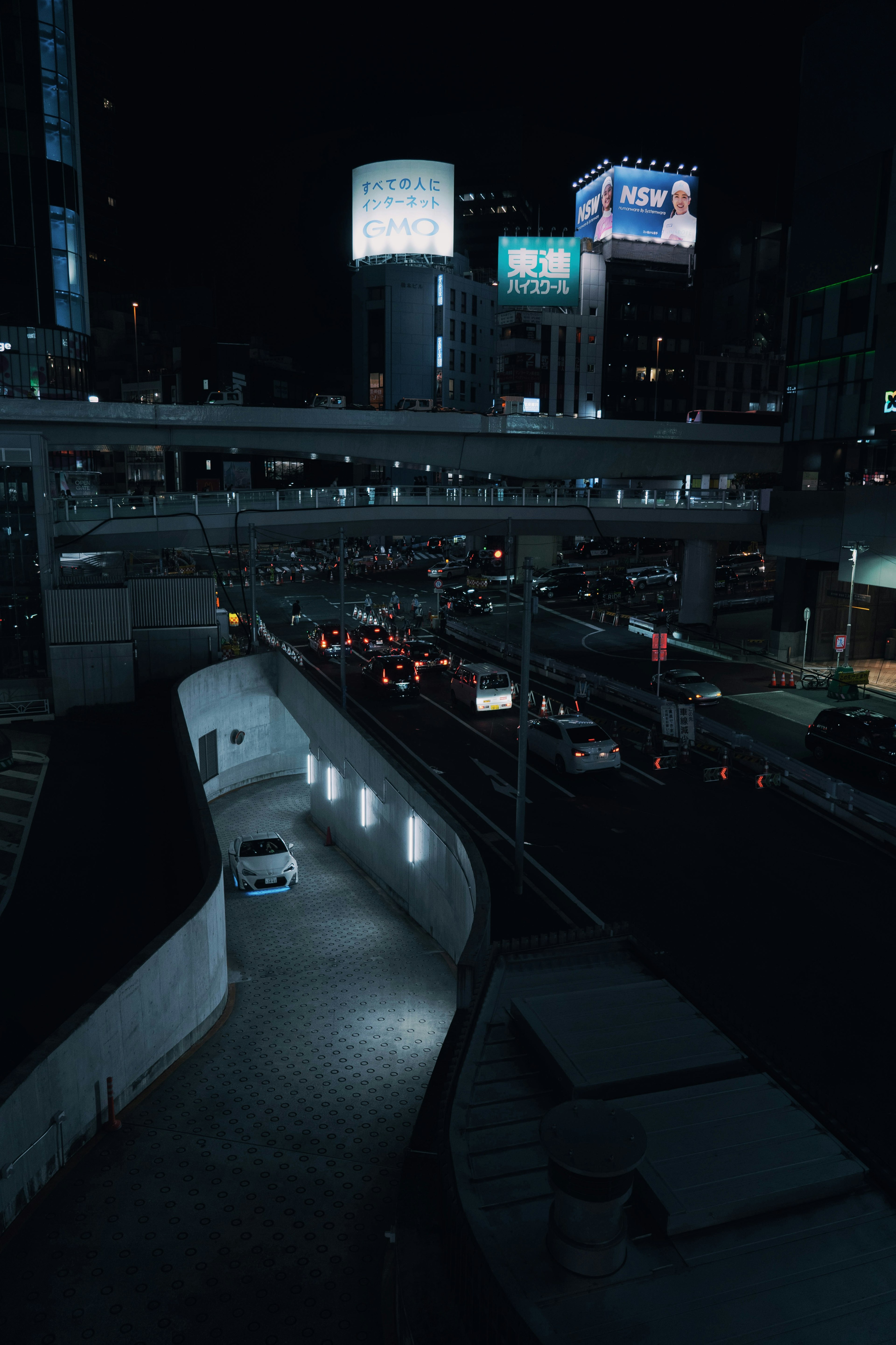 Night cityscape featuring illuminated billboards and flowing traffic