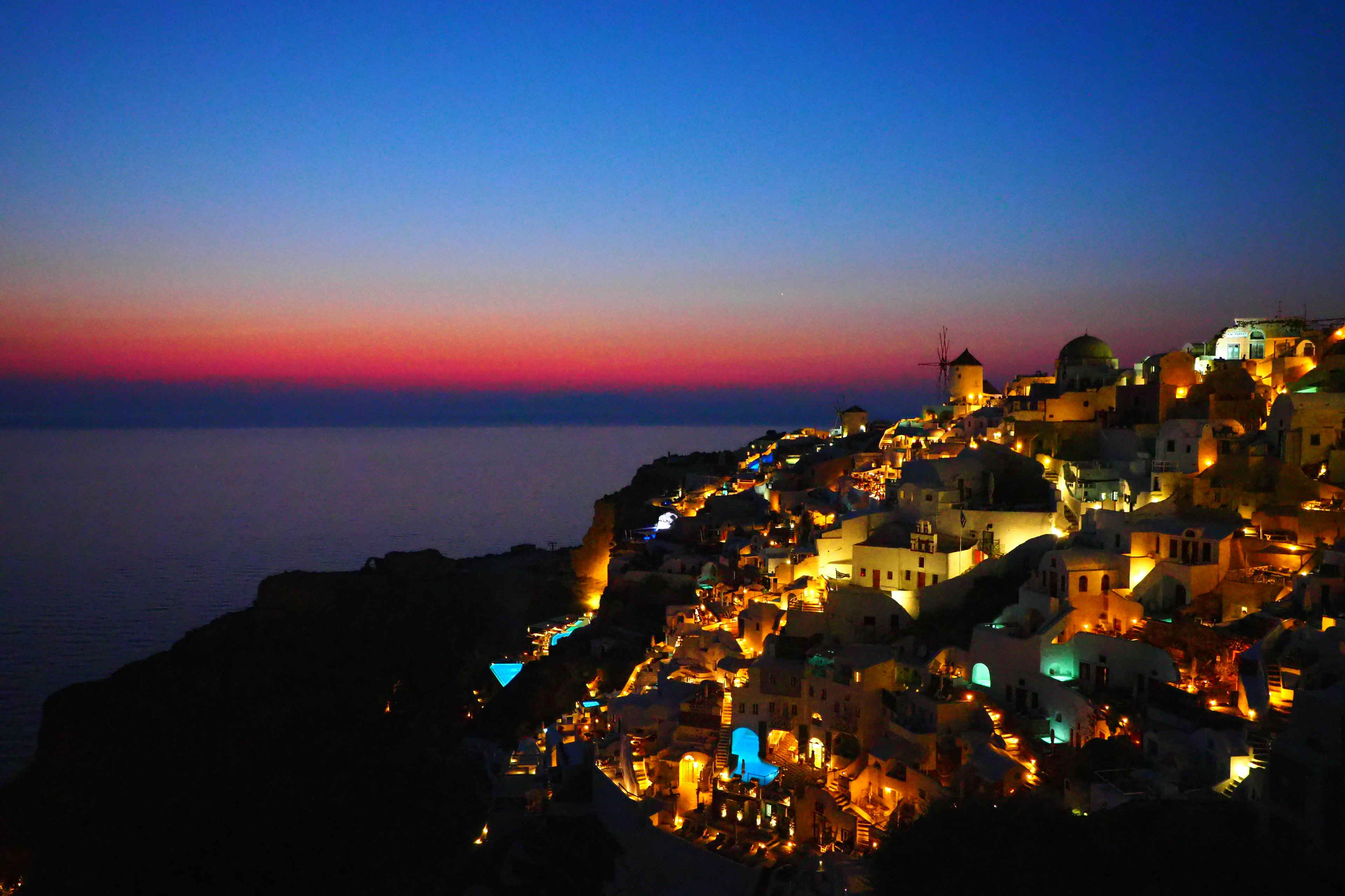 Beautiful coastal town illuminated at dusk with a vibrant sky