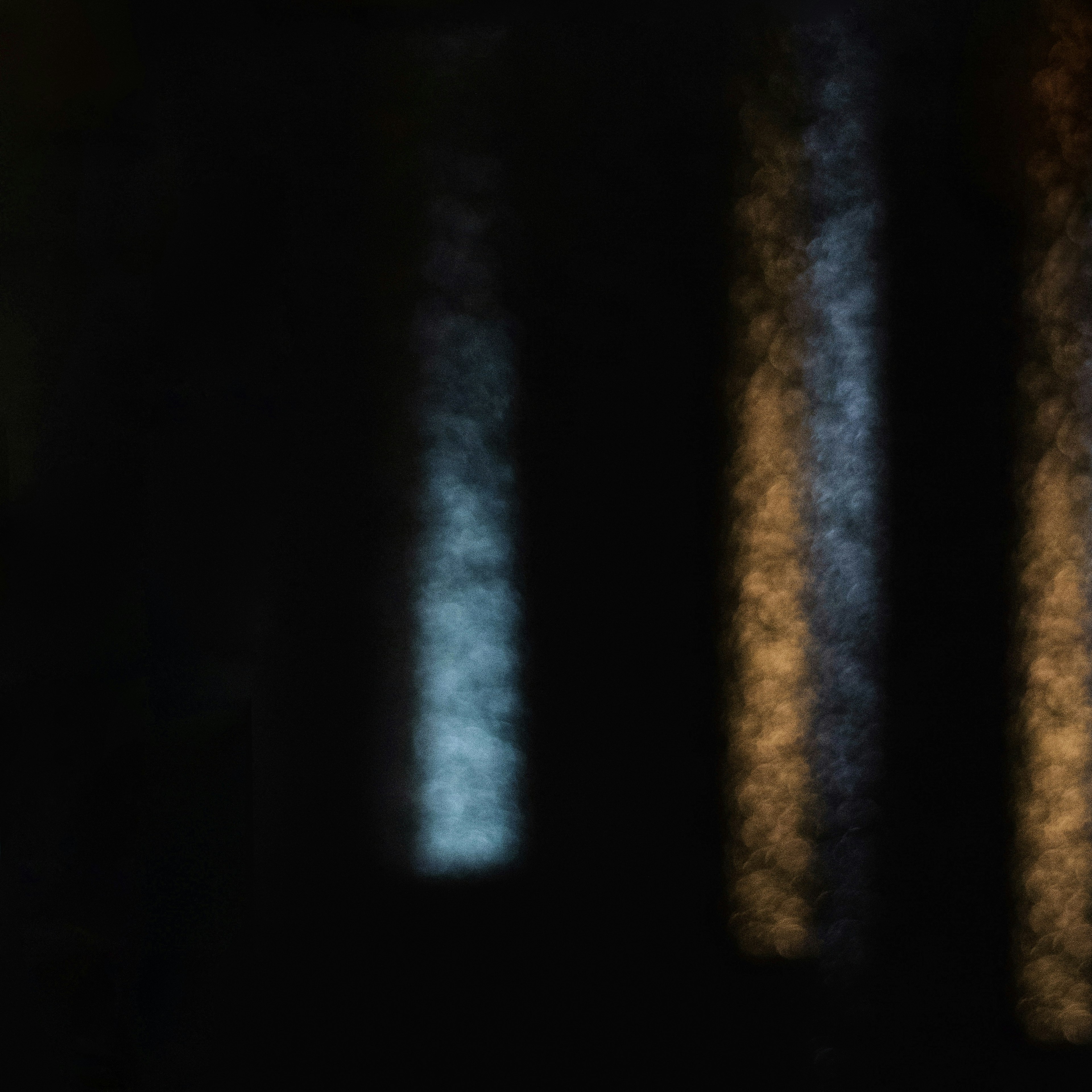 Abstract image featuring blue and orange light streaks against a dark background